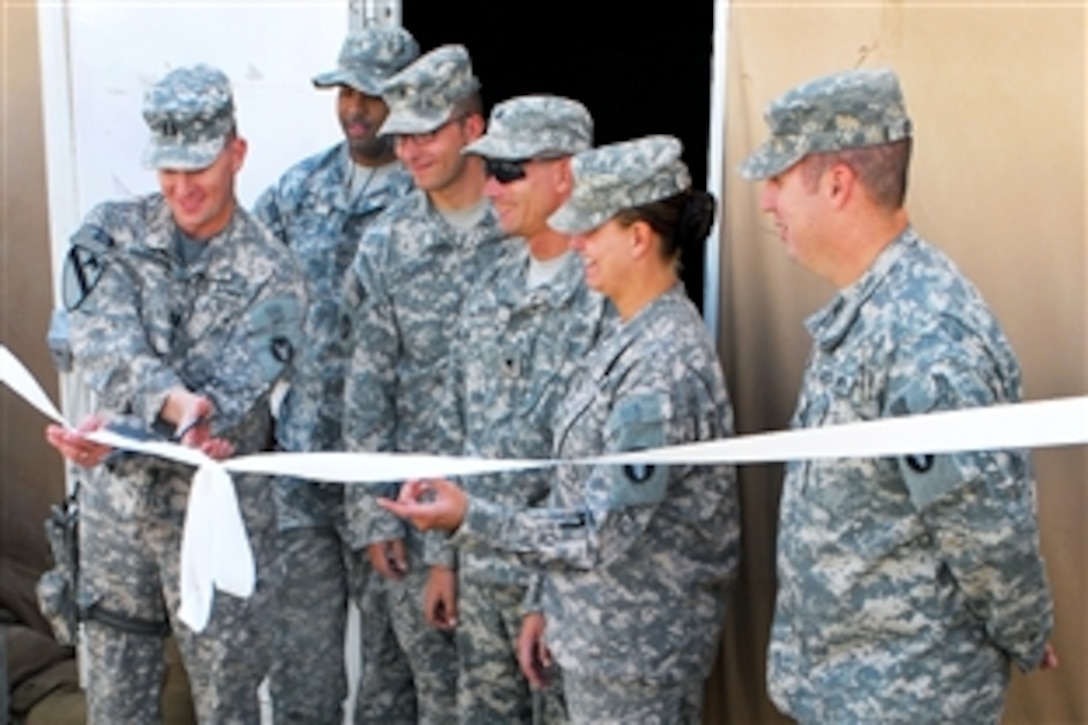 U.S. Army Capt. David Markgraf cuts the ribbon to open the new Morale, Welfare, and Recreation facility for troops on Contingency Operating Base Basra, Iraq, Oct. 4, 2009. Markgraf, assigned to 34th Infantry Division, commended the crew for helping to build the facility.