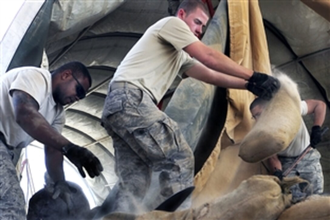 U.S. Air Force airmen take down a tent structure on Ali Base, Iraq, Sept. 30, 2009. The airmen, assigned to the 407th Expeditionary Civil Engineer Squadron, are downsizing and consolidating materials and equipment to send to U.S. warfighters in Afghanistan.
