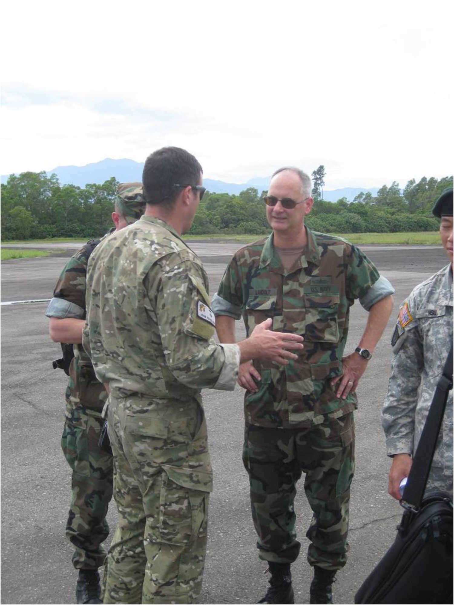 TABING AIRFIELD, Indonesia -- Maj. John Traxler briefs Rear Adm. Richard Landolt, the Amphibious Force Seventh Fleet commander, here Oct. 7 on the airfield's capabilities after U.S. and Indonesian forces surveyed and opened the closed airfield. U.S. Air Force combat controllers and Indonesian Air Force air traffic controllers are now manning the airfield to support fixed and rotary wing aircraft supporting humanitarian relief operations near Padang in western Indonesia. (Courtesy photo) 
