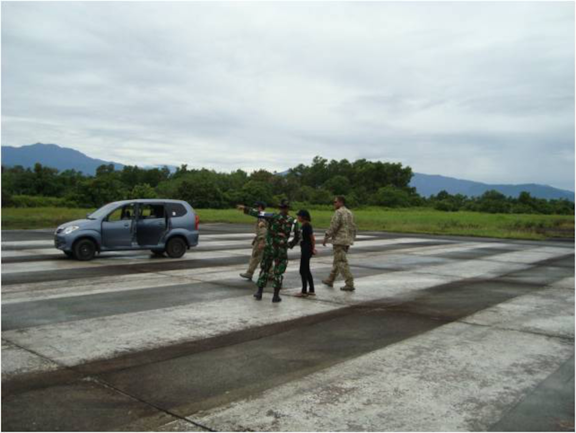 TABING AIRFIELD, Indonesia -- Combat controllers from the 353rd Special Operations Group and Indonesian military officials survey the runway here Oct. 4 to see if the airfield can support humanitarian relief operations near Padang in western Indonesia. The combat controllers and Indonesian Air Force air traffic controllers are now manning the airfield to support fixed and rotary wing aircraft assisting relief operations. (Courtesy photo) 