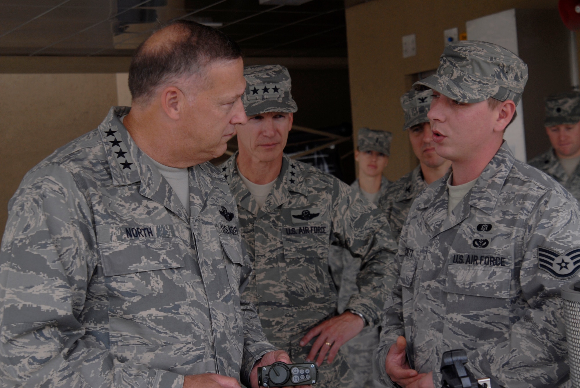 KUNSAN AIR BASE, Republic of Korea -- Gen. Gary North, Pacific Air Forces commander, talks to Staff Sgt. Joshua Prickett, 8th Civil Engineer Squadron, about the new Airmen's dormitory during his tour here Oct. 4. General North took a tour through Kunsan's newest Airmen's dorms and one of the oldest dorms. (U.S. Air Force photo/Staff Sgt. Darnell T. Cannady)