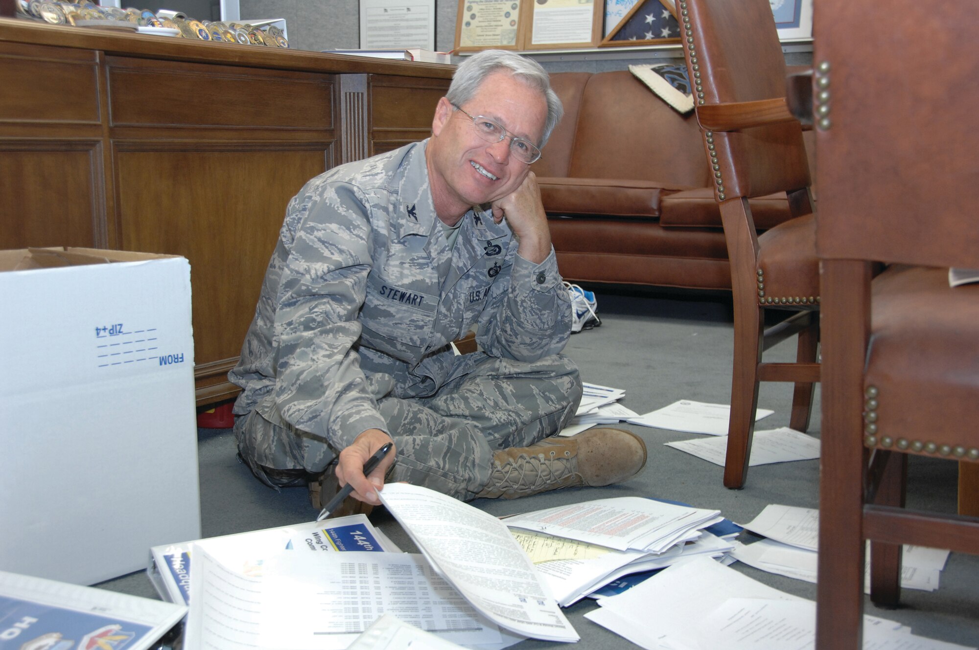 163rd Reconnaissance Wing Vice Commander Col. Bruce Stewart organizes papers and files for the UCI. (U.S.Air Force photo by Master Sgt. Julie Avey)
