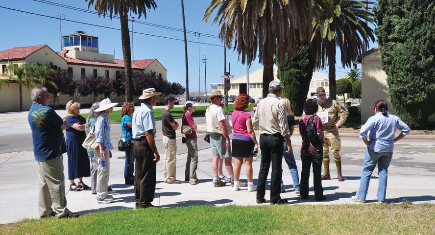Master Sgt. John P. Hale stands in front of building 301, explaining its original function. In the background is the 452nd Air Mobility Wing Headquarters. Sergeant Hale explains this building was constructed to be the headquarters building and has always served that purpose. (U.S. Air Force photo by Staff Sgt. Megan Crusher)