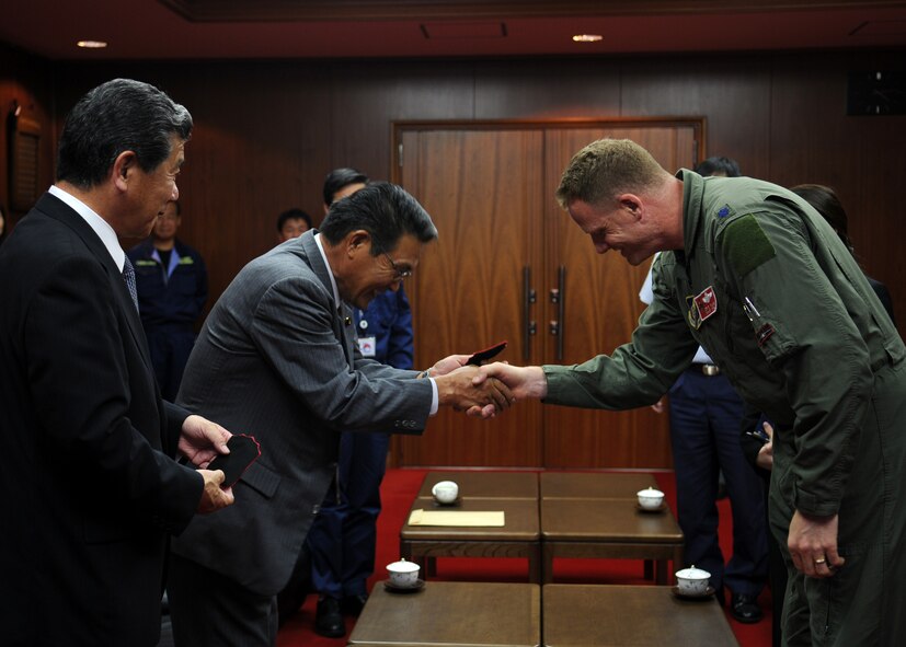 Lt. Col. Steve Plank, Det. Commander for ATR Hyakuri and pilot with the 67th Fighter Squadron, Kadena Air Base, Japan, presents squadron patches to Omitama City Mayor, Joichi Shimada, and Assembly Deputy Chairman, Tsutomu Nakamur, after meeting with them to discuss the events of the week, future bilateral training, and further cultural exchanges at Hyakuri Air Base, Japan, Oct. 07. The squadron is participating in an Aviation Training Relocation exercise between the U.S. Air Force and the Japan Air Self Defense Force from Oct. 5-9, 2009.
