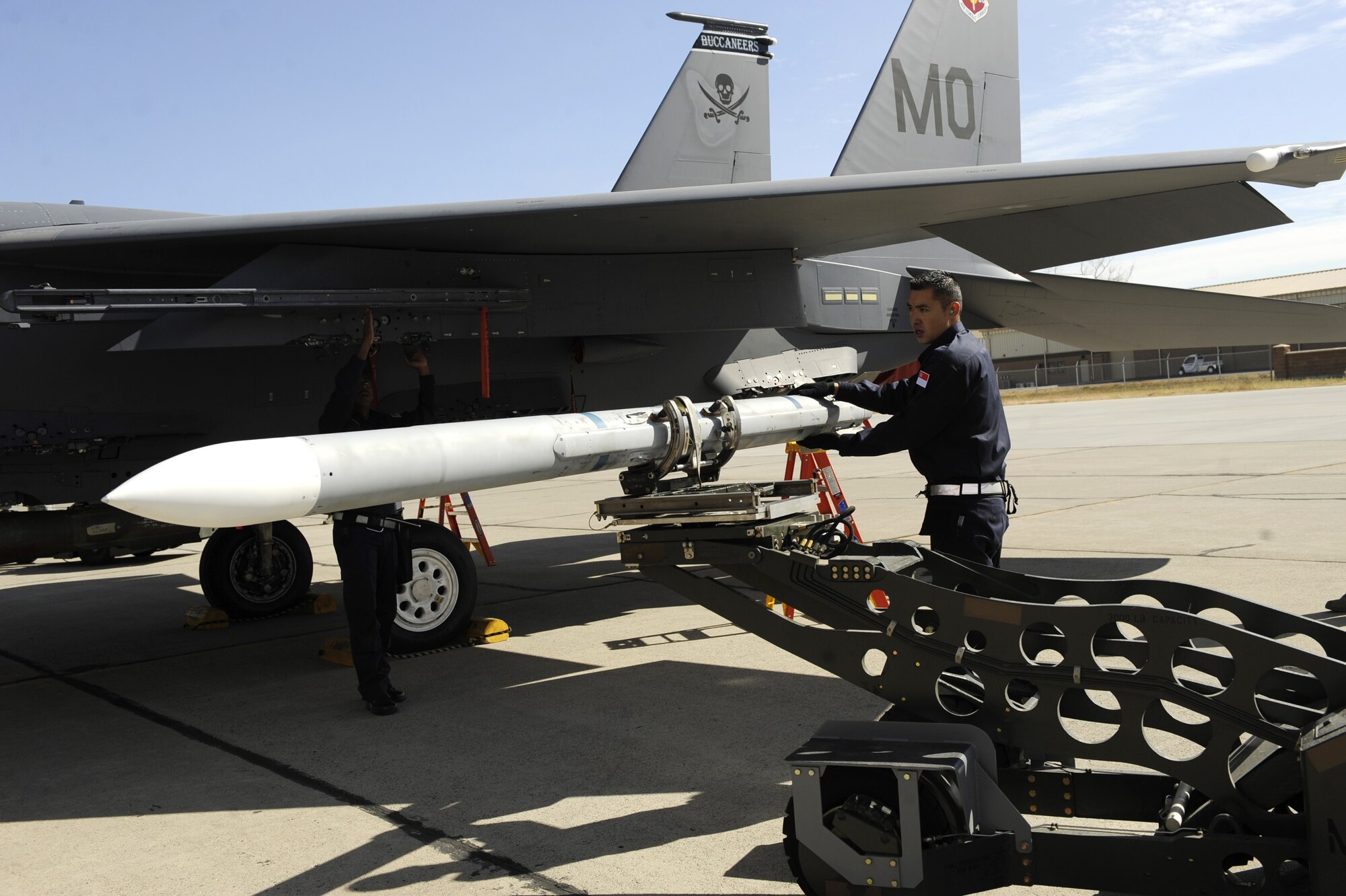 MOUNTAIN HOME AIR FORCE BASE, Idaho -- Master Sgt. Gene Tan, 428th Fighter Squadron flightline crew, guides the AIM-9LM sidewinder onto the F-15SG aircraft during the Weapons Load Crew Competition Oct. 2. The 428th FS went on to take its first victory winning the competition by only one point. (U.S. Air Force photo by Airman 1st Class Renishia Richardson)