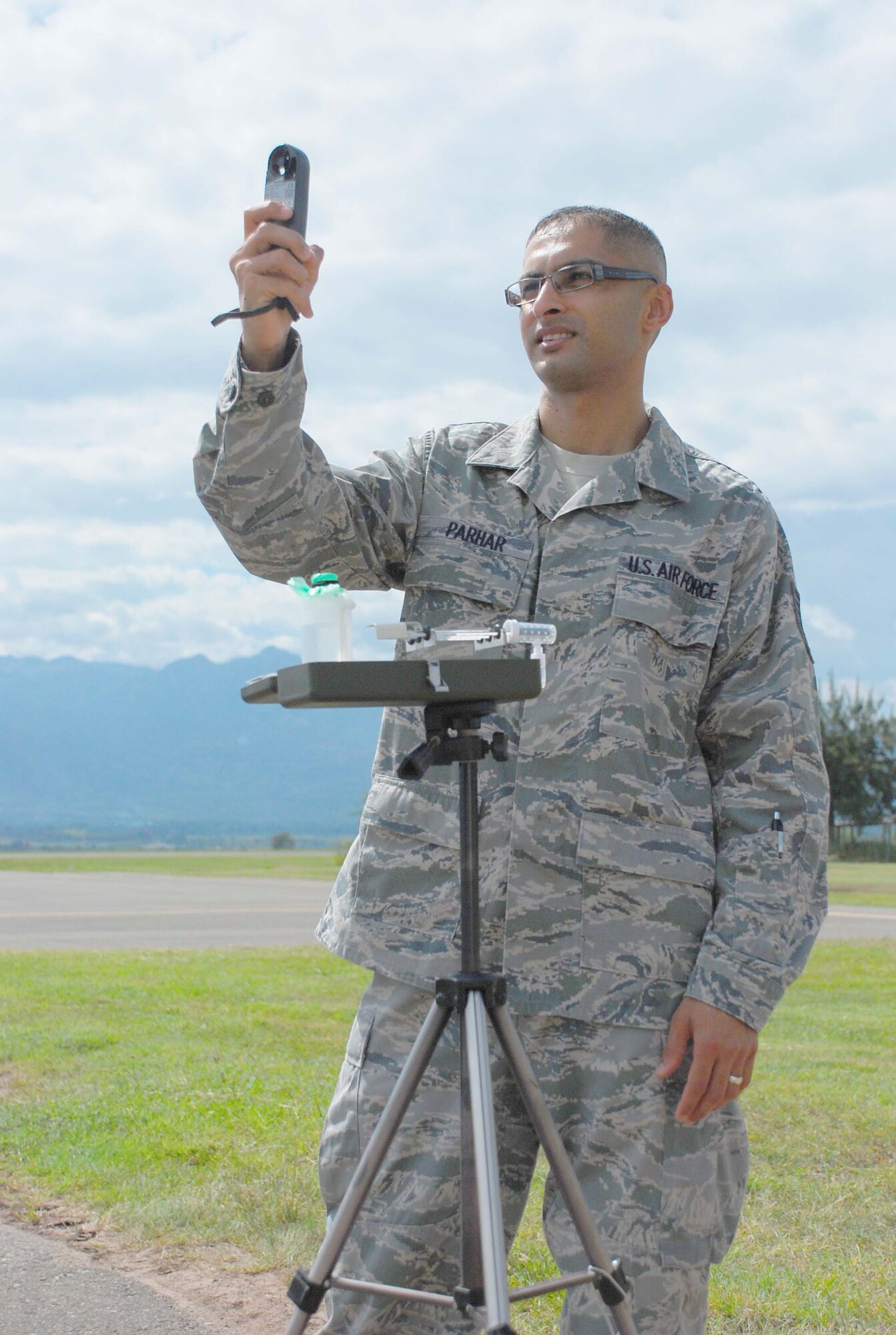 SOTO CANO AIR BASE, Honduras — Tech. Sgt Dasveer Parhar, an Air Force weatherman with the 612th Air Base Squadron, measures winds, temperature, dewpoint and pressure with a handheld Kestrel Oct. 5 in front of the base operations building. Sergeant Parhar was recently named the 12th Air Force NCO of the Quarter. He said he has been a weatherman for 11 years, and he likes how important weather is to the mission (U.S. Air Force photo/Staff Sgt. Chad Thompson).