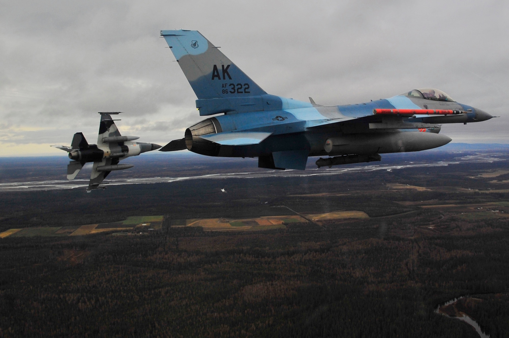 A pair of F-16 Fighting Falcon Aggressors fly over Eielson Air Force Base during RED FLAG-Alaska 10-1, Oct. 8, 2009. RF-A provides participants 67,000 square miles of airspace, one conventional bombing range and two tactical bombing ranges containing more than 400 different types of targets and more than 30 threat simulators. (U.S. Air Force photo/Staff Sgt. Christopher Boitz)