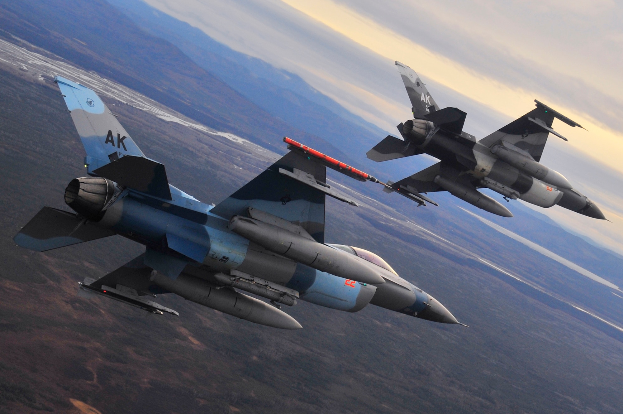 A pair of F-16 Fighting Falcon Aggressors fly over the Joint Pacific Alaska Range Complex during RED FLAG-Alaska 10-1 Oct. 8, 2009, Eielson Air Force Base, Alaska. The JPARC has 67,000 square miles of airspace, one conventional bombing range and two tactical bombing ranges containing more than 400 different types of targets and more than 30 threat simulators. (U.S. Air Force photo/Staff Sgt. Christopher Boitz)