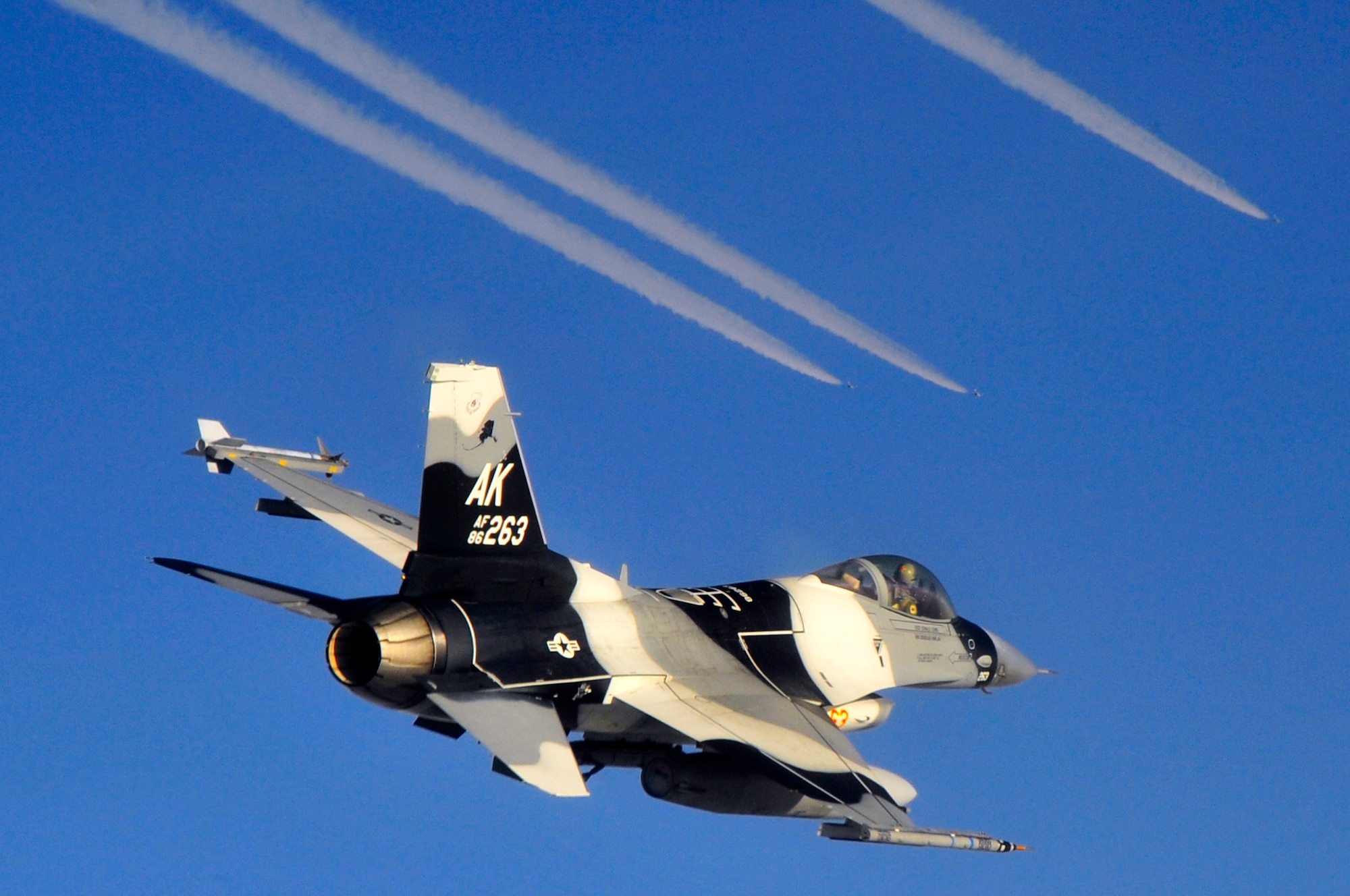An F-16 Fighting Falcon Aggressor and other participants fly over the Joint Pacific Alaska Range Complex during RED FLAG-Alaska 10-1 Oct. 8, 2009, Eielson Air Force Base, Alaska. RF-A is a Pacific Air Forces-directed field training exercise poised at giving aircrews their first 10 flights in simulated air combat conditions. (U.S. Air Force photo/Staff Sgt. Christopher Boitz)