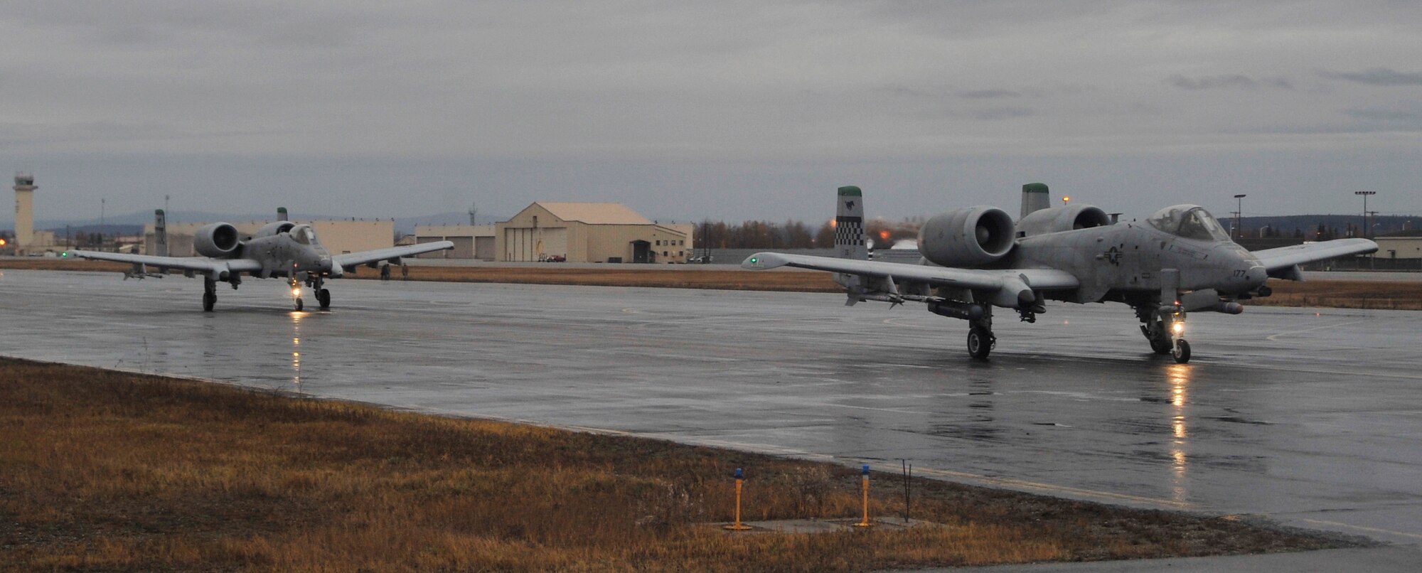 A pair of A-10 Thunderbolt II's from Osan Air Base, Republic of Korea, taxi toward the runway during RED FLAG-Alaska 10-1 Oct. 8, 2009, Eielson Air Force Base, Alaska. RF-A is a Pacific Air Forces-directed field training exercise poised at giving aircrews their first 10 flights in simulated air combat conditions.(U.S. Air Force photo/Staff Sgt. Christopher Boitz)