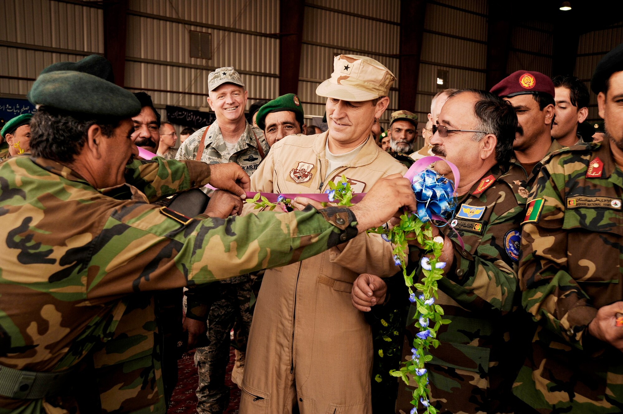 Brig. Gen. Mike Boera helps cut a ceremonial ribbon at an Afghan National Army Air Corp wing activation Oct. 5, 2009, at Kandahar Airfield, Afghanistan. The wing is the ANAAC's second and supports Mi-17 helicopter operations and training. General Boera is the Commanding General of Combined Air Power Transition Force, Combined Security Transition Command-Afghanistan. (U.S. Air Force photo/Staff Sgt. Angelita Lawrence)