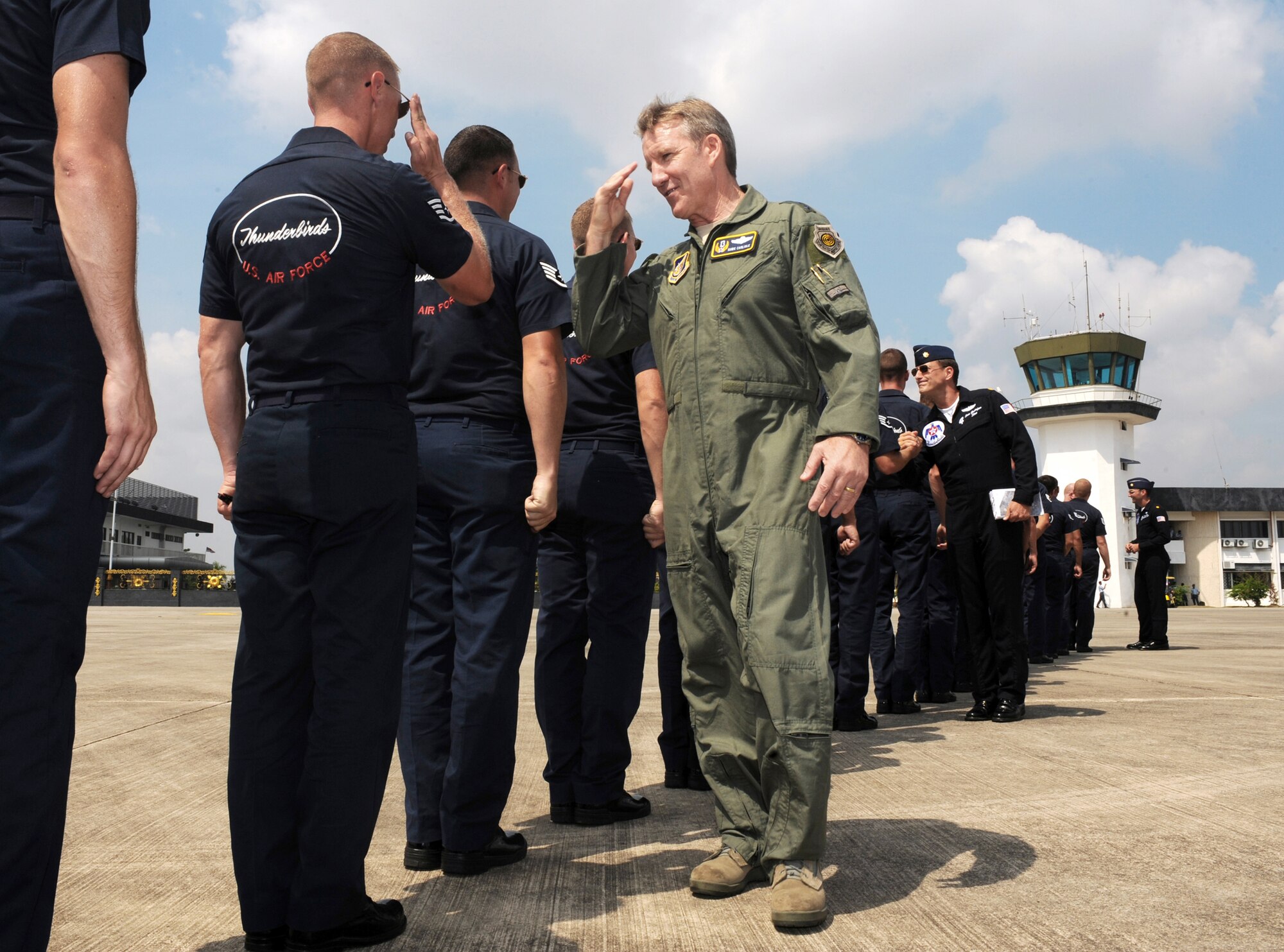 Lt. Gen. Herbert J. "Hawk" Carlisle greets the Thunderbirds maintenance team prior to his flight with the team during an airshow Oct. 2, 2009, at Kuala Lumpur, Malaysia. The U.S. Air Force Air Demonstration Squadron, the Thunderbirds, participated in the Malaysian air show. General Carlisle is the 13th Air Force commander. (U.S. Air Force photo/Staff Sgt. Kristi Machado) 