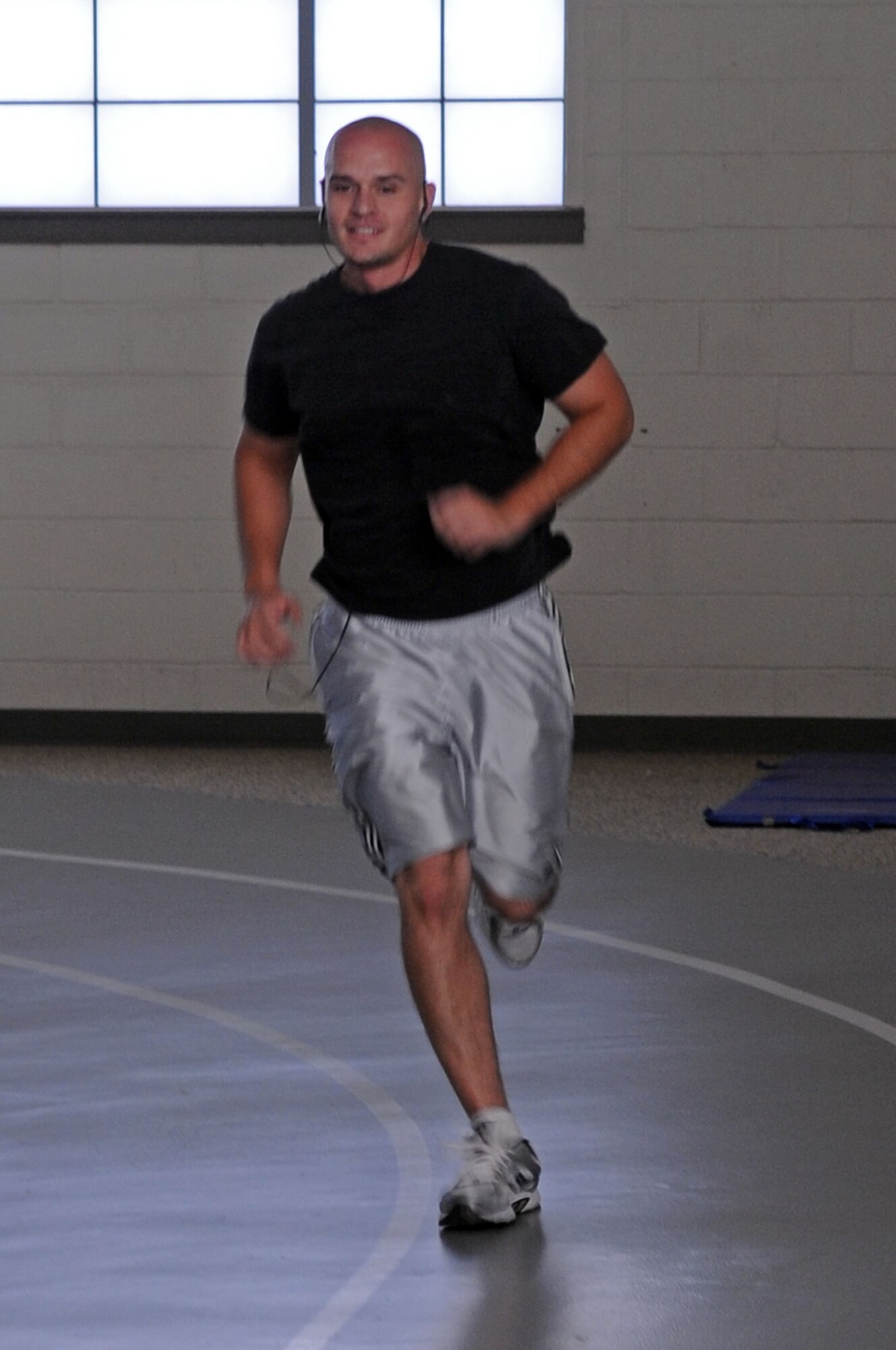 Senior Airman Anthony Chacon, 2d Aircraft Maintenance Squadron, runs around the indoor track in the Barksdale fitness center during his physical training session. (U.S. Air Force photo by Senior Airman La’Shanette V. Garrett) (RELEASED)