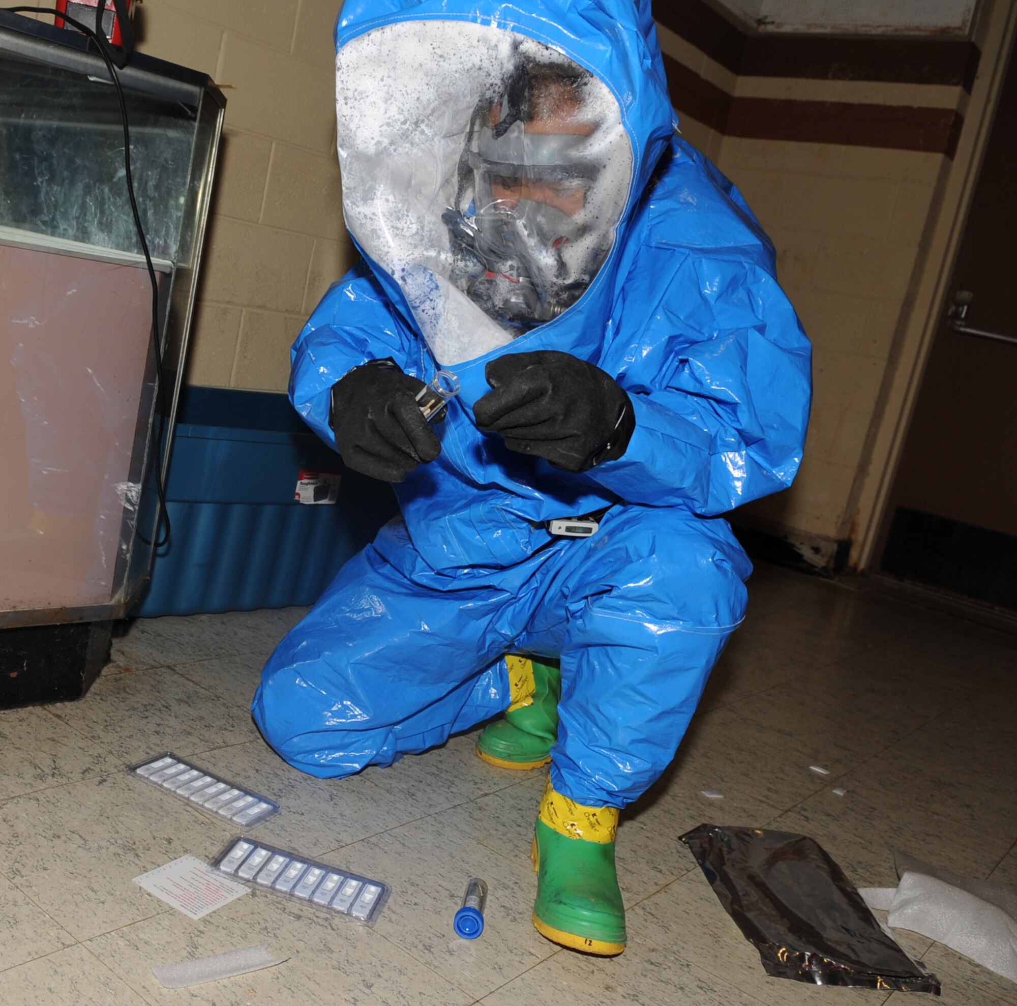 Staff Sgt. Lee Sang, 2d Medical Group bio-environmental engineer, tests a powdery substance found in the Base Theater during a major accident response exercise Sept. 29.  During the MARE, several scenarios were exercised. The fire department, security forces personnel and medical personnel all responded to each scenario. (U.S. Air Force photo by Senior Airman Alexandra M. Longfellow) (RELEASED)