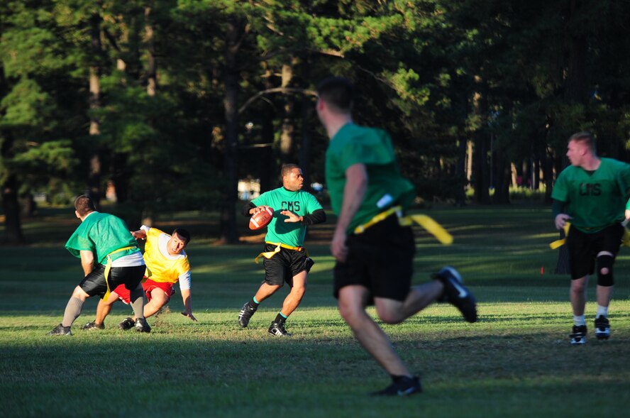 Ryan Williams, 4th Component Maintenance Squadron’s intramural flag football team quarterback, prepares to pass the ball to a teammate during the championship game at Seymour Johnson Air Force Base, N.C., Oct. 7, 2009. Each team played a strong game throughout both halves. In a closely matched game victory went to the 4th AMXS with a final score of 14 to 13. (U.S. Air Force photo/Airman 1st Class Rae Perry)