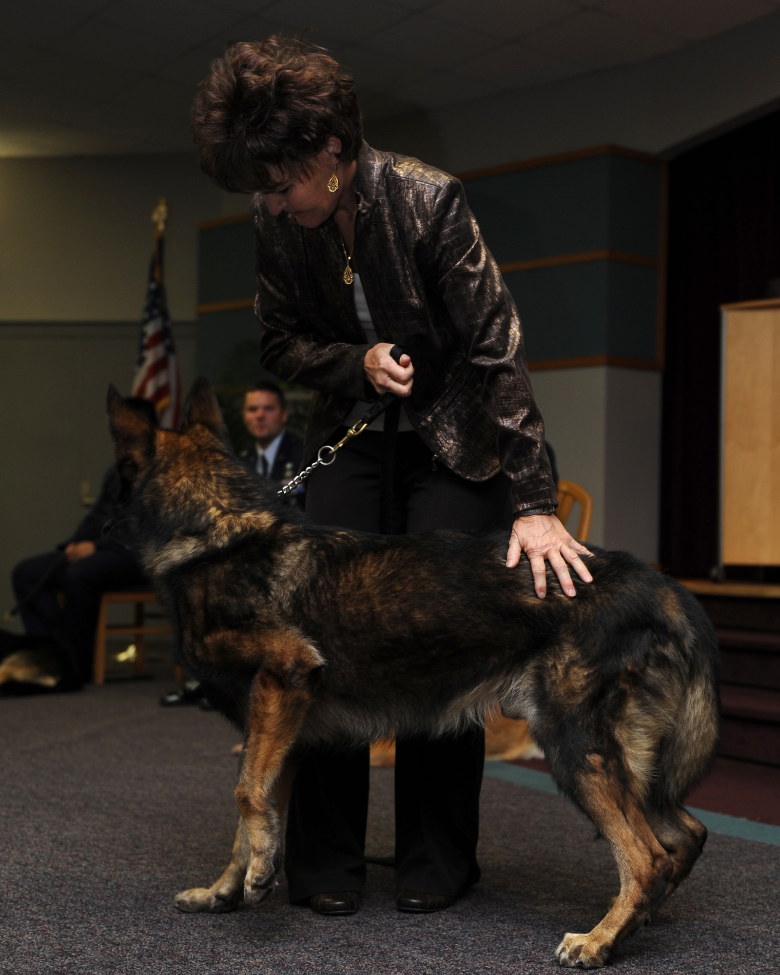 WHITEMAN AIR FORCE BASE, Mo. – Military Working Dog, Charlie greets his new owner Teresa Arguelles during his retirement ceremony from active duty, Oct 8. MWDs Charlie, Joost, Rico, and Tina retired from active duty service Oct. 8 after more than 35  combined years of service to their country. (U.S. Air Force Photo/ Senior Airman Cory Todd)