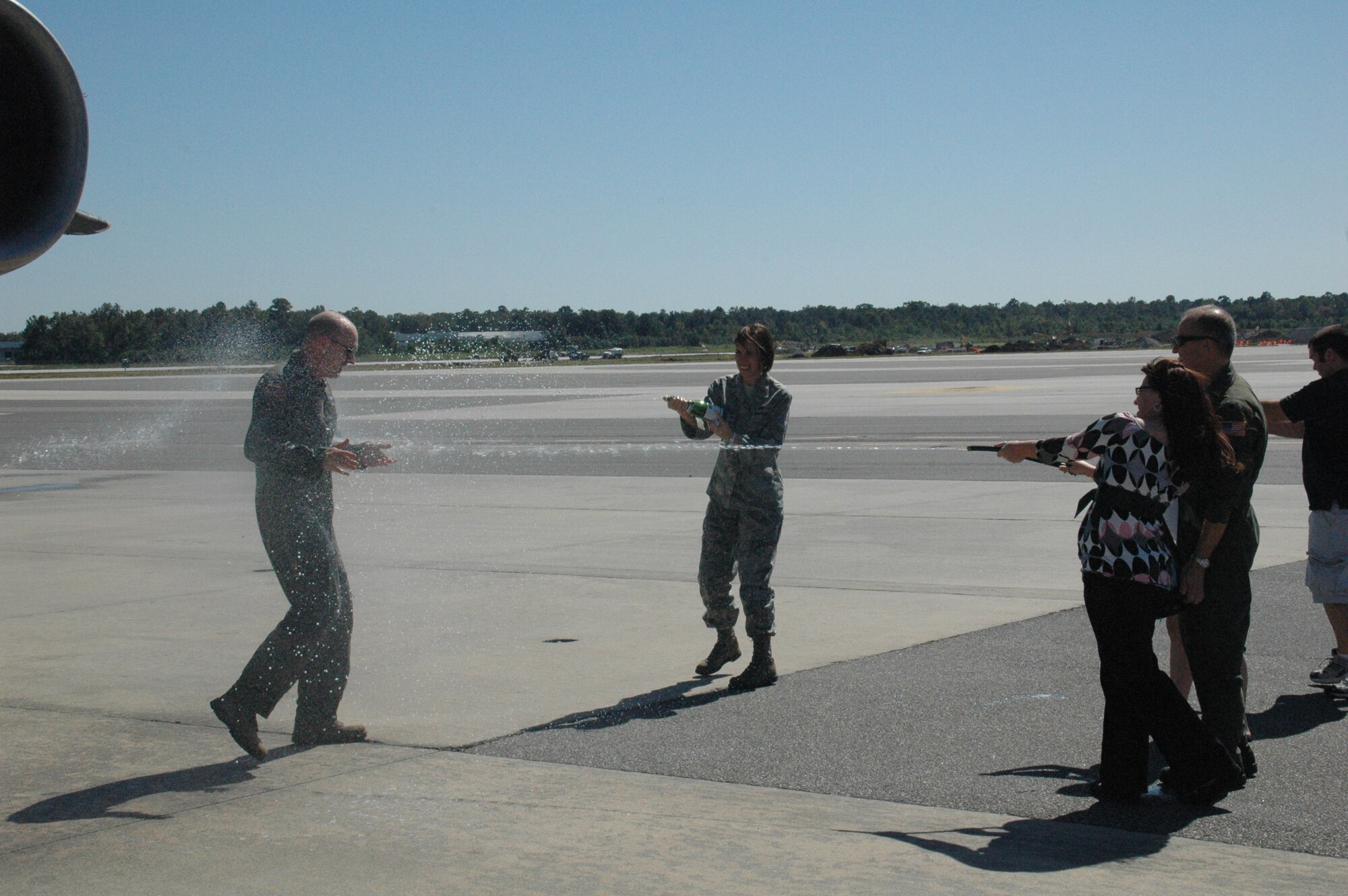 Chantel Jensen and her family spray her husband, Col. Jay Jensen, 315th Operations Group commander, with water after he completed his fini flight . Colonel Jensen soon leaves for a new position at Air Force Reserve Command Hedaquarters, Robins AFB, Ga. and will be replaced by Colonel Terry Lawrence Oct. 11, 2009. Colonel Lawrence comes from Niagara Fall Air Reserve Station, N.Y.
