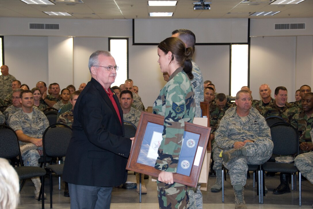 Chief Master Sgt. (Ret.) Richard Smith(Former Air National Guard Command Chief) Congratulates members of the 125th Fighter Wing who have just been awarded the "Hometown Heroes Salute" award which is given to those who served on Active Duty since September 11, 2001. Over 600 people were recognized at a Ceremony held here October 4, 2009. (Air  Force Photo by Tech. Sgt. Shelley Gill)