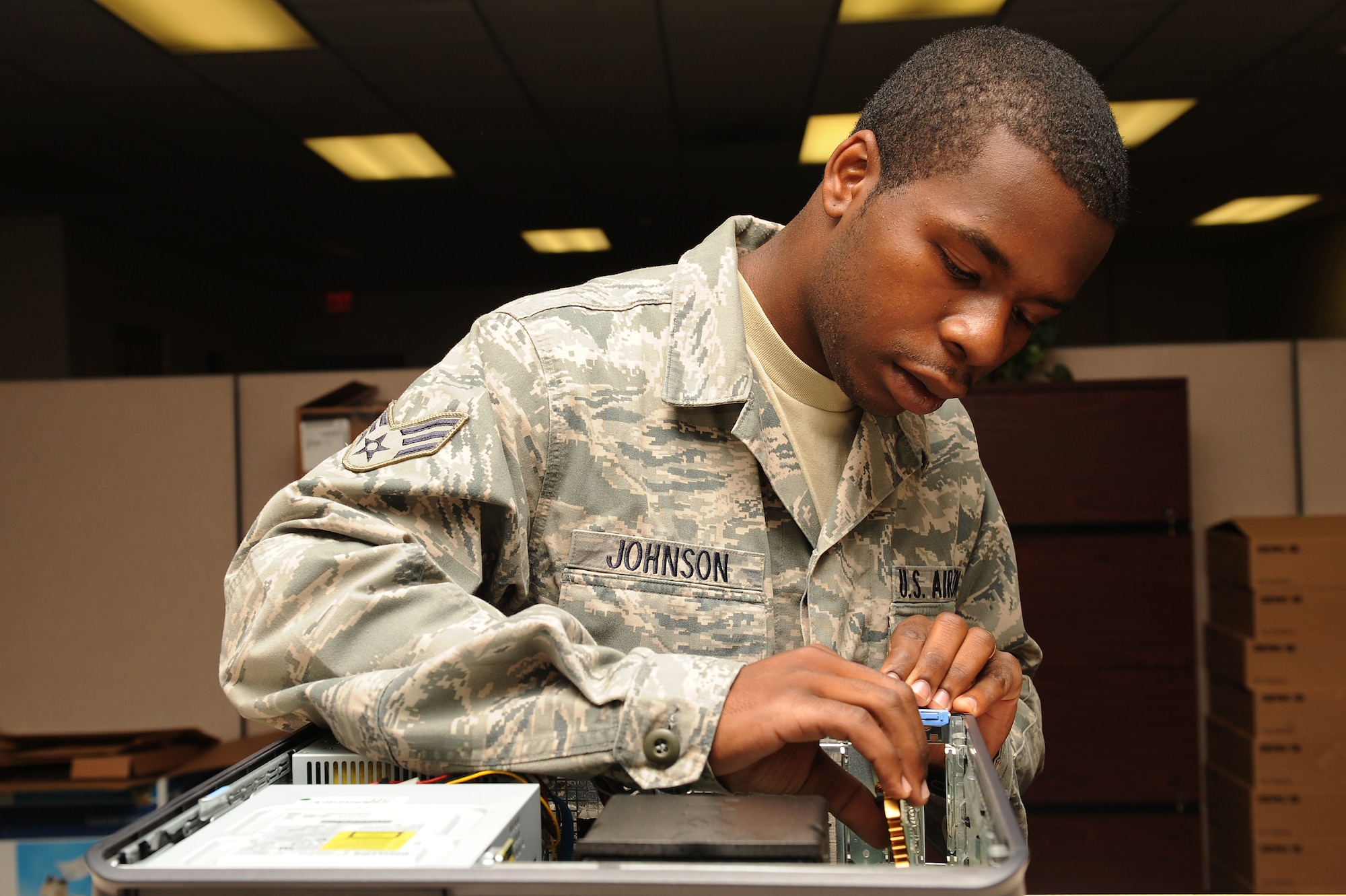 Senior Airman Nathaniel Johnson III, 4th Communications Squadron client support administrator, inserts a video card into computer processing unit on Seymour Johnson Air Force Base, N.C., Oct. 1, 2009. Without a video card images cannot be shown on a computer screen. (U.S. Air Force photo/Airman 1st Class Whitney Lambert)
