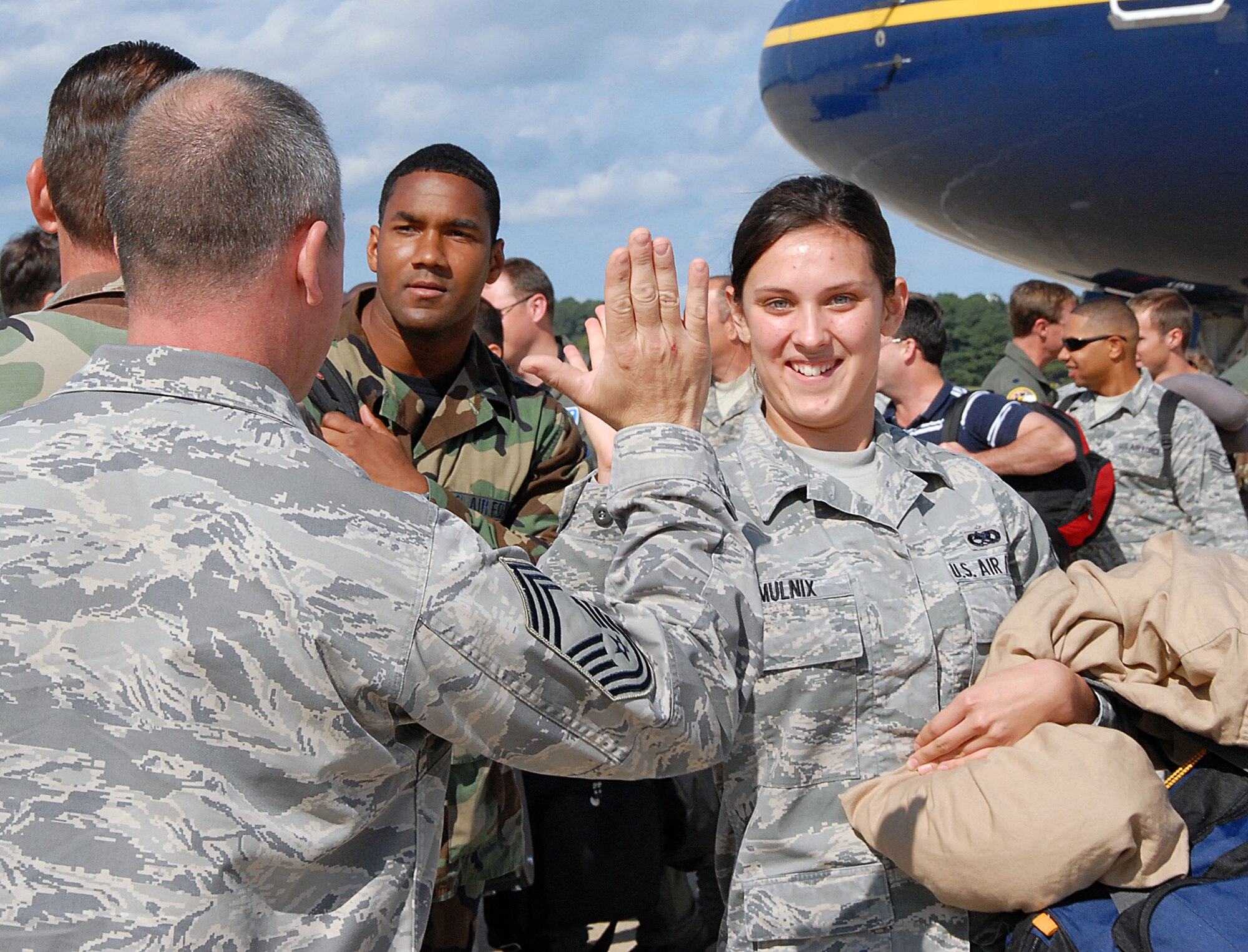 LANGLEY AIR FORCE BASE, Va. – Chief Master Sgt. Mike J. Bouley, 192nd Fighter Wing,  greets Airman Chelsea B. Mulnix, 94th Fighter Squadron, here Oct. 1.  Over 150 Langley Airmen returned from a 120-day deployment to Kadena Air Base, Japan.  The goal of the deployment was to support the Pacific Theater Security Package and ensure stability in the region. (U.S. Air Force Photo/Master Sgt. Carlos J. Claudio)