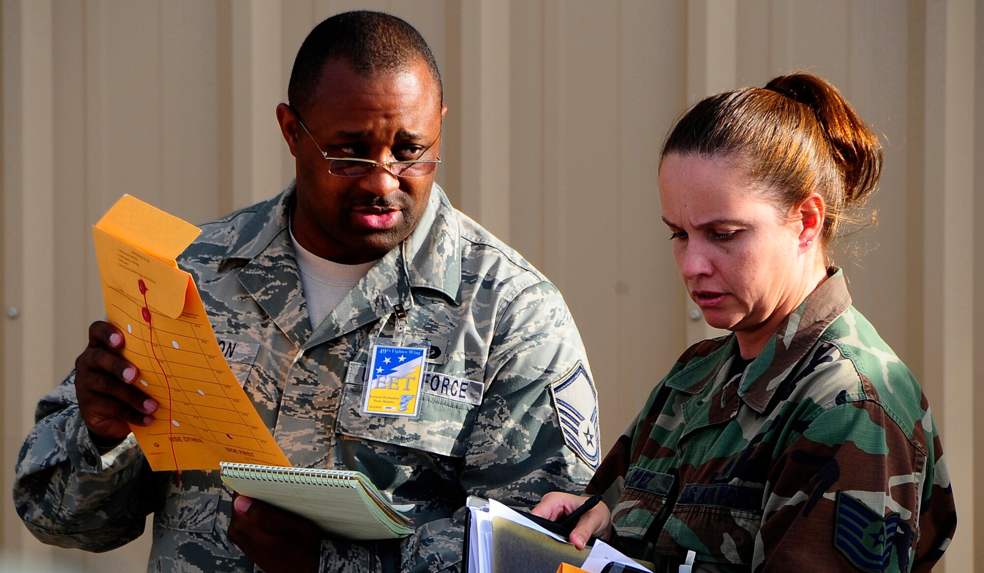 HOLLOMAN AIR FORCE BASE, N.M. -- Master Sgt. Terry Jefferson and Tech. Sgt. Loretta Lopez, from the 49th Force Support Squadron, double check processing rosters during a Phase 1 exercise here Oct. 8. The exercise scenario consisted of processing Airmen for deployment. (U.S. Air Force photo by Tech. Sgt. Chris Flahive)