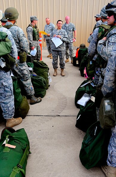 HOLLOMAN AIR FORCE BASE, N.M. -- Capt. Roxzanna Ponce De Leon, from the 49th Force Support Squadron, gives direction to Airmen during the Phase 1 exercise here Oct. 8. During the exercise, Airmen from all over the base processed through a deployment line, taking the necessary steps for a deployment. (U.S. Air Force photo by Tech. Sgt. Chris Flahive)