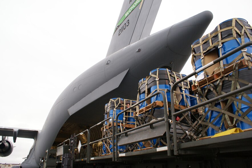 ELMENDORF AIR FORCE BASE, Alaska – Members of Elmendorf's 732nd Air Mobility Squadron load cargo on board a McChord C-17 Globemaster III Oct. 7. More than 58,000 pounds of cargo - seven pallets of fuel for expeditionary hospital emergency generators and three pallets of medical supplies, ultimately destined for Indonesia - were loaded aboard the aircraft. (U.S. Air Force photo/Staff Sgt. Eric Burks)