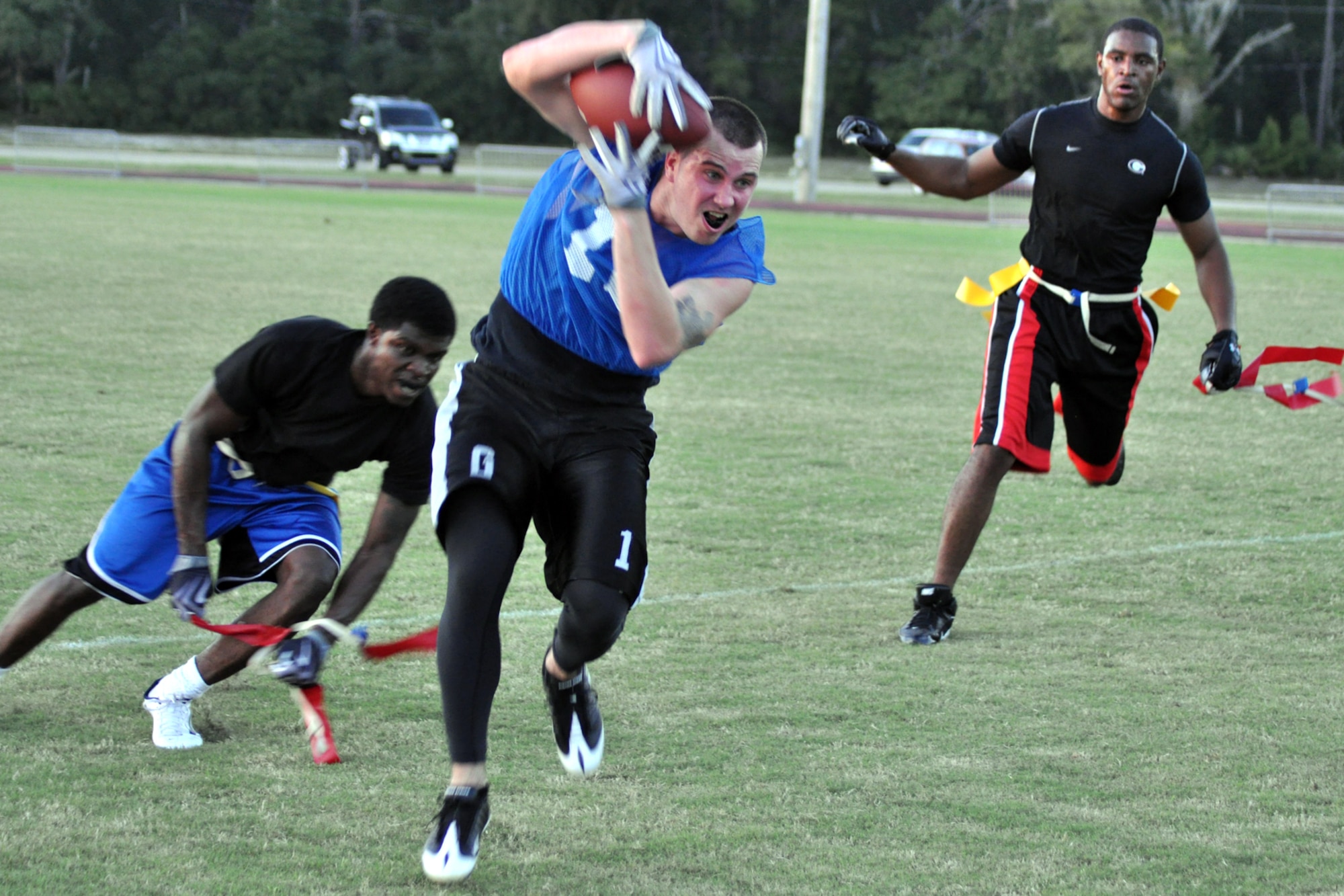 EGLIN AIR FORCE BASE, Fla. – Tech. Sgt. Troy Kiick, 96th Force Support Squadron quarterback, makes a run for the goal line but has his flag pulled by Senior Airman David Hendricks, 96th Logistics Readiness Squadron, during a flag football preseason game Oct. 6. 96th LRS team won 13-0. Regular season begins Oct. 12. (U.S. Air Force photo/ Airman Anthony Jennings)