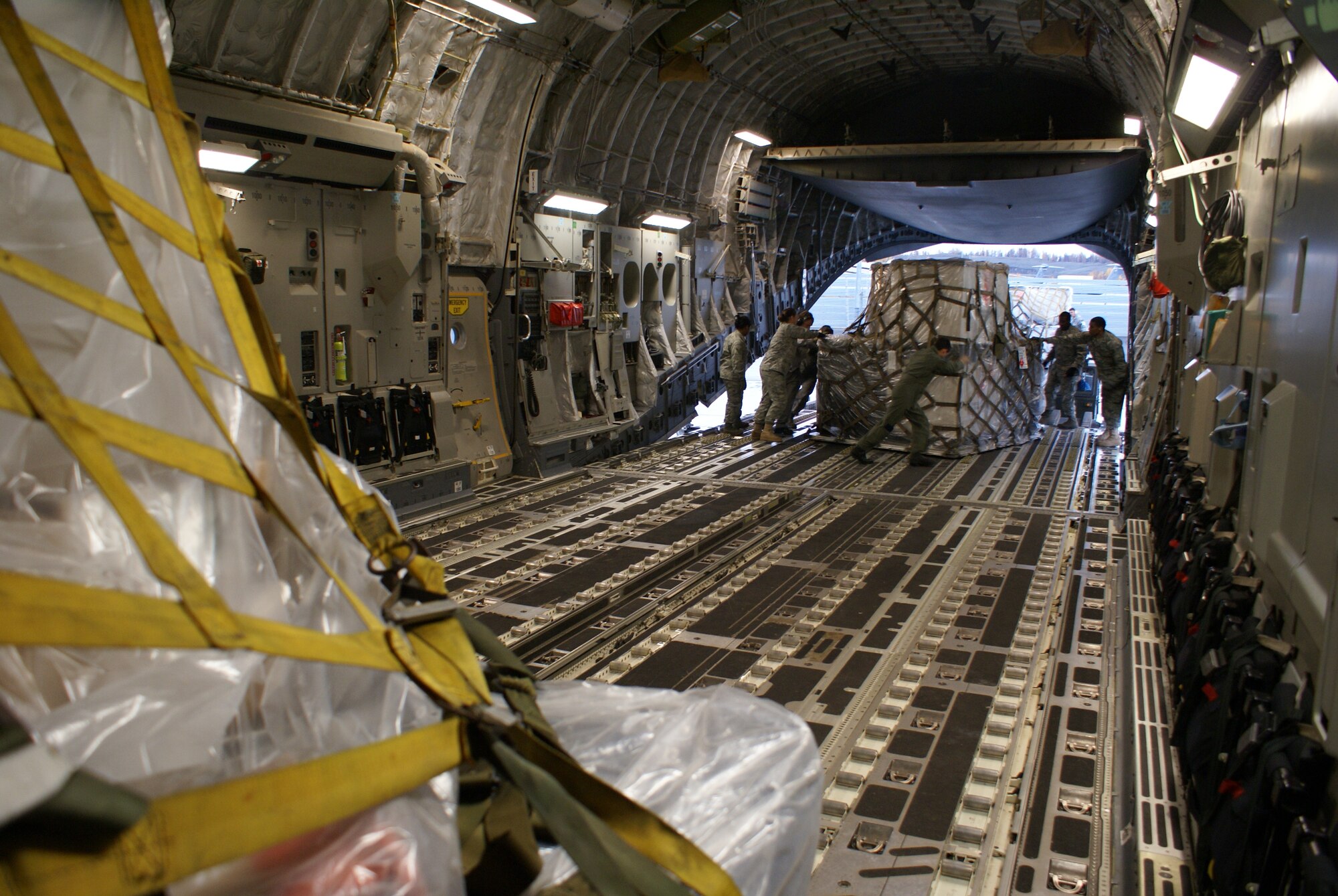Elmendorf Air Force Base, Alaska, 732nd Air Mobility Squadron Airmen and McChord 7th Airlift Squadron Airmen load cargo on board a McChord C-17 Globemaster III Oct. 7. More than 58,000 pounds of cargo - seven pallets of fuel for expeditionary hospital emergency generators and three pallets of medical supplies, ultimately destined for Indonesia - were loaded aboard the aircraft. (U.S. Air Force photo/Staff Sgt. Eric Burks)