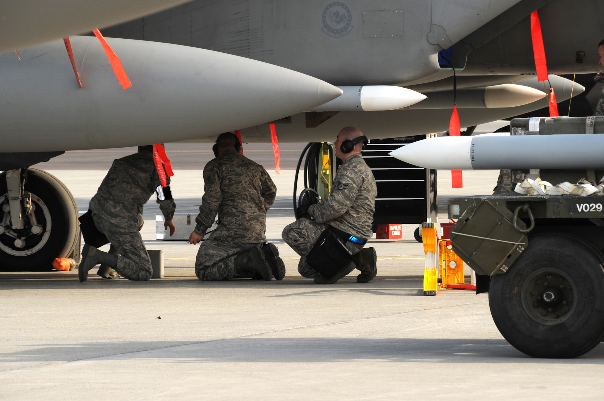 ELMENDORF AIR FORCE BASE, Alaska -- The 19th Aircraft Maintenance Unit's load crew team load chaff and flare on an F-15 as part of the load crew competition Oct. 2. Load competitions increase load crew efficiency and builds a sense of camaraderie for weapons troops. The 19th AMU was the first team to finish the competition. (U.S. Air Force Photo/ Senior Airman Cynthia Spalding)