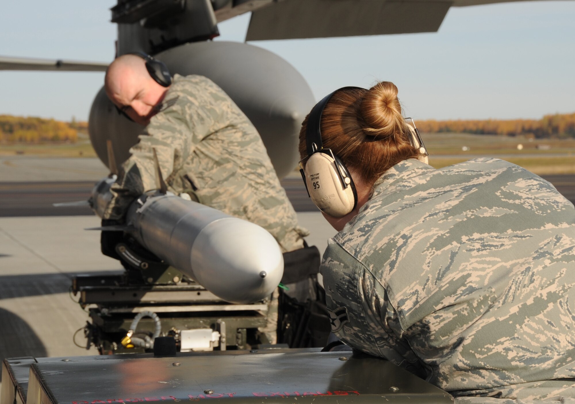 ELMENDORF AIR FORCE BASE, Alaska -- Staff Sgt. Shawn O'neill and Airman 1st Class Shelley Schofield prepares munition trailor for removal of missils before loading onto the F-15 Oct. 2. Three load teams from the 3rd Wing's Aircraft Maintenance Units participated in a load crew competition on the flightline Oct. 2. O'Neill and Schofield are Aircraft Armament specialists with the 19th Aircraft Maintenance Unit.  (U.S. Air Force Photo/ Senior Airman Cynthia Spalding)