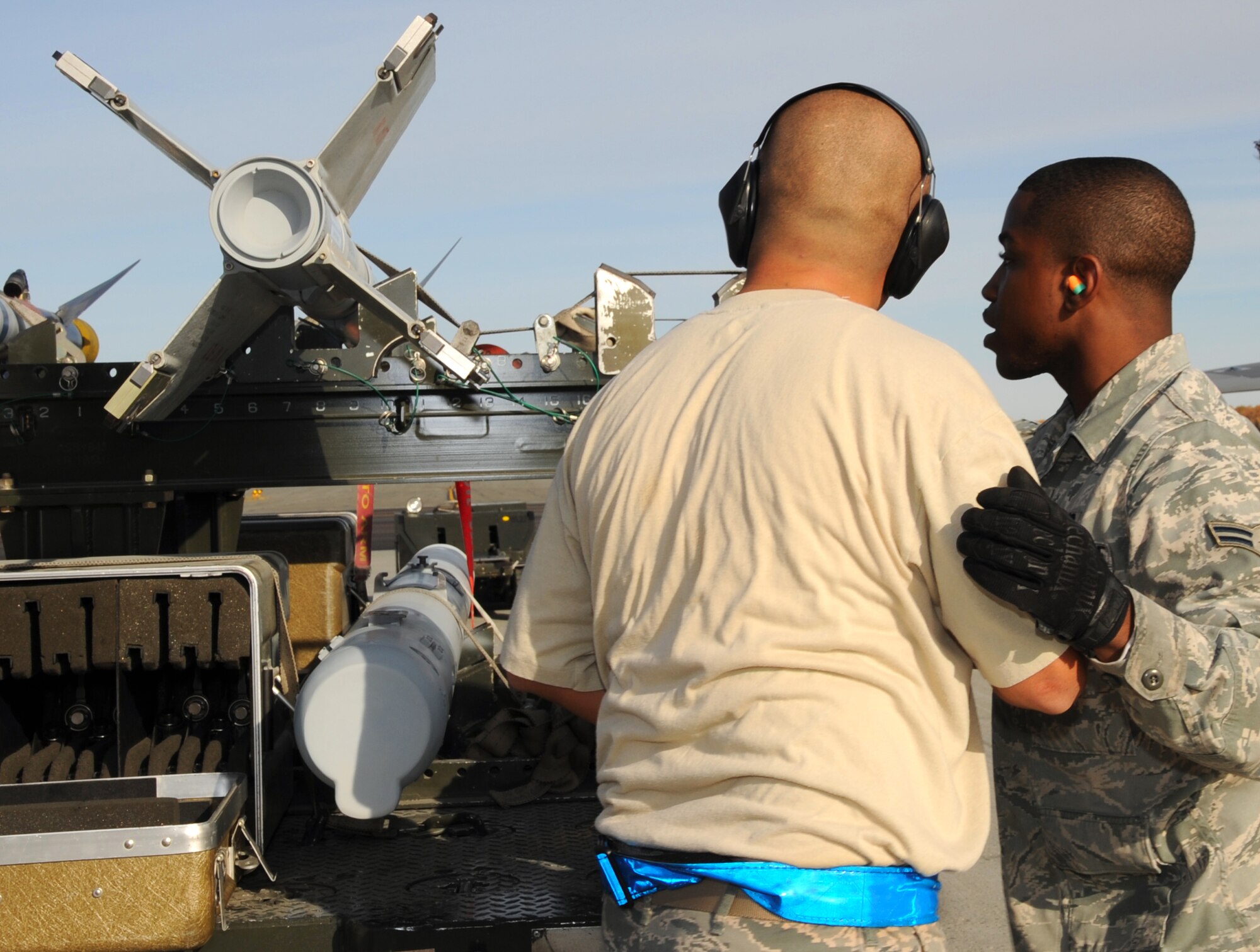 ELMENDORF AIR FORCE BASE, Alaska -- Staff Sgt. Miguel Duarte and Airman 1st Class William Moses inspect munitions prior to loading onto the F-22 during the load crew competition Oct 2. Load competitions increase load crew efficiency and builds a sense of camaraderie for weapons troops. Duarte and Moses are both Aircraft Armament specialists with the 525th Aircraft Maintenance Unit. (U.S. Air Force Photo/ Senior Airman Cynthia Spalding)