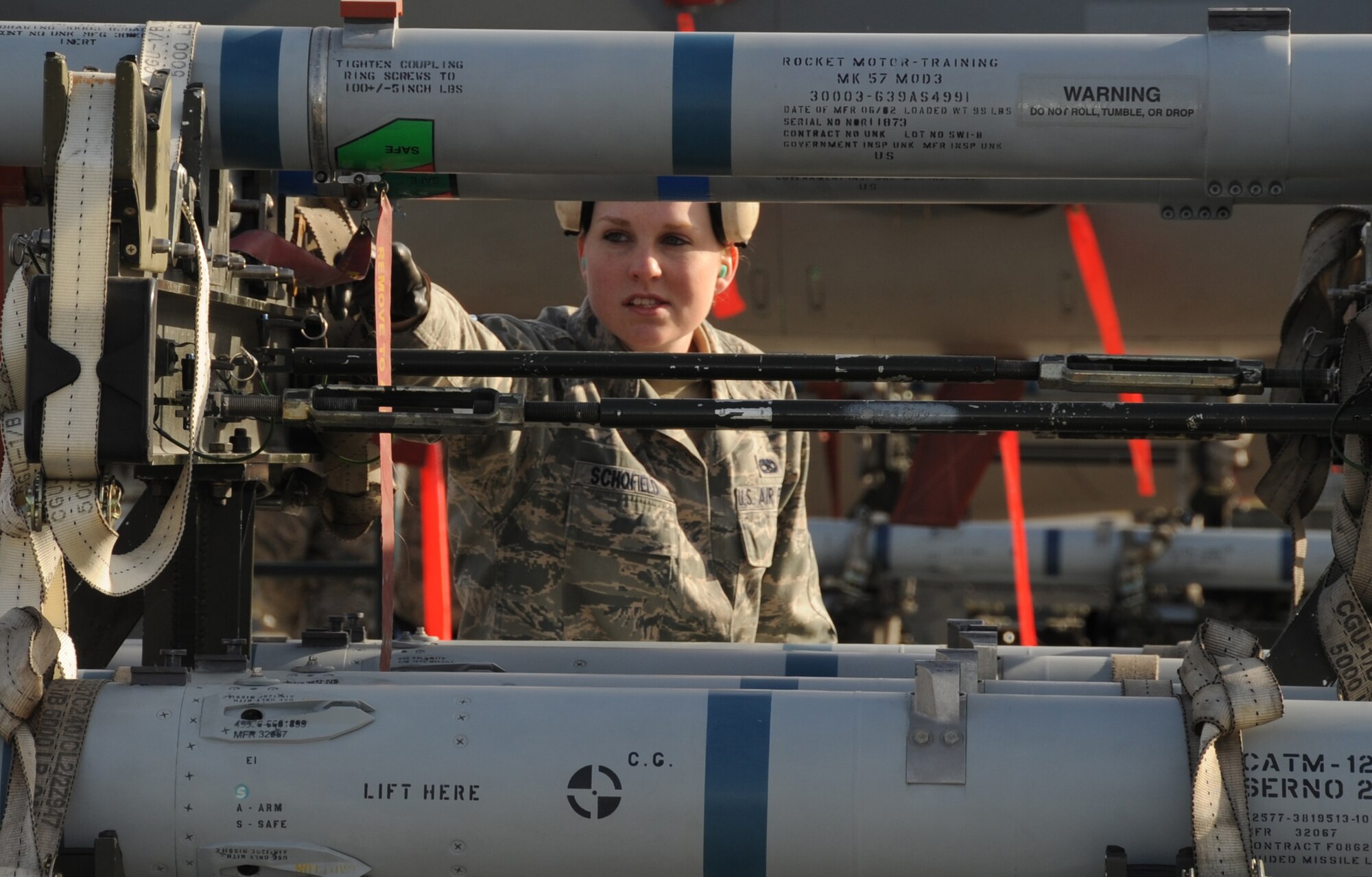 ELMENDORF AIR FORCE BASE, Alaska -- Airman 1st Class Shelley Schofield prepares a munitions trailer for removal of missiles during the load competition Oct. 2. Load competitions increase load crew efficiency and builds a sense of camaraderie for weapons troops. Schofield is an Aircraft Armament specialist with the 19th Aircraft Maintenance Unit. (U.S. Air Force Photo/ Senior Airman Cynthia Spalding)

