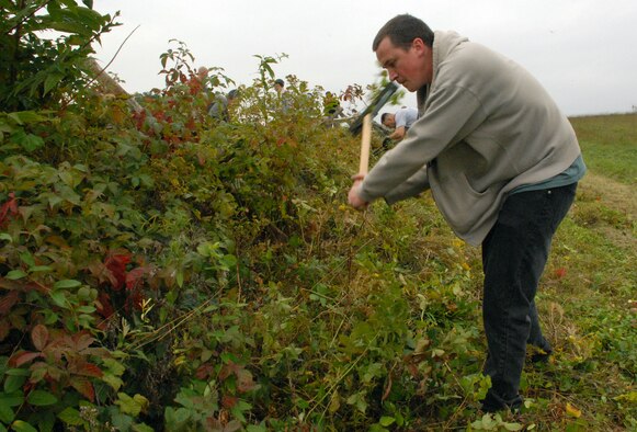 Staff Sgt. Shawn Bishop, 436th Maintenance Squadron, uses a sickle to remove leaves from fence lines and stone walls during the annual Gettysburg Cleanup Oct. 2. There were more than 50 Team Dover volunteers at the Gettysburg National Military Park in Pennsylvania. (U.S. Air Force photo/ Airman 1st Class Shen-Chia Chu)