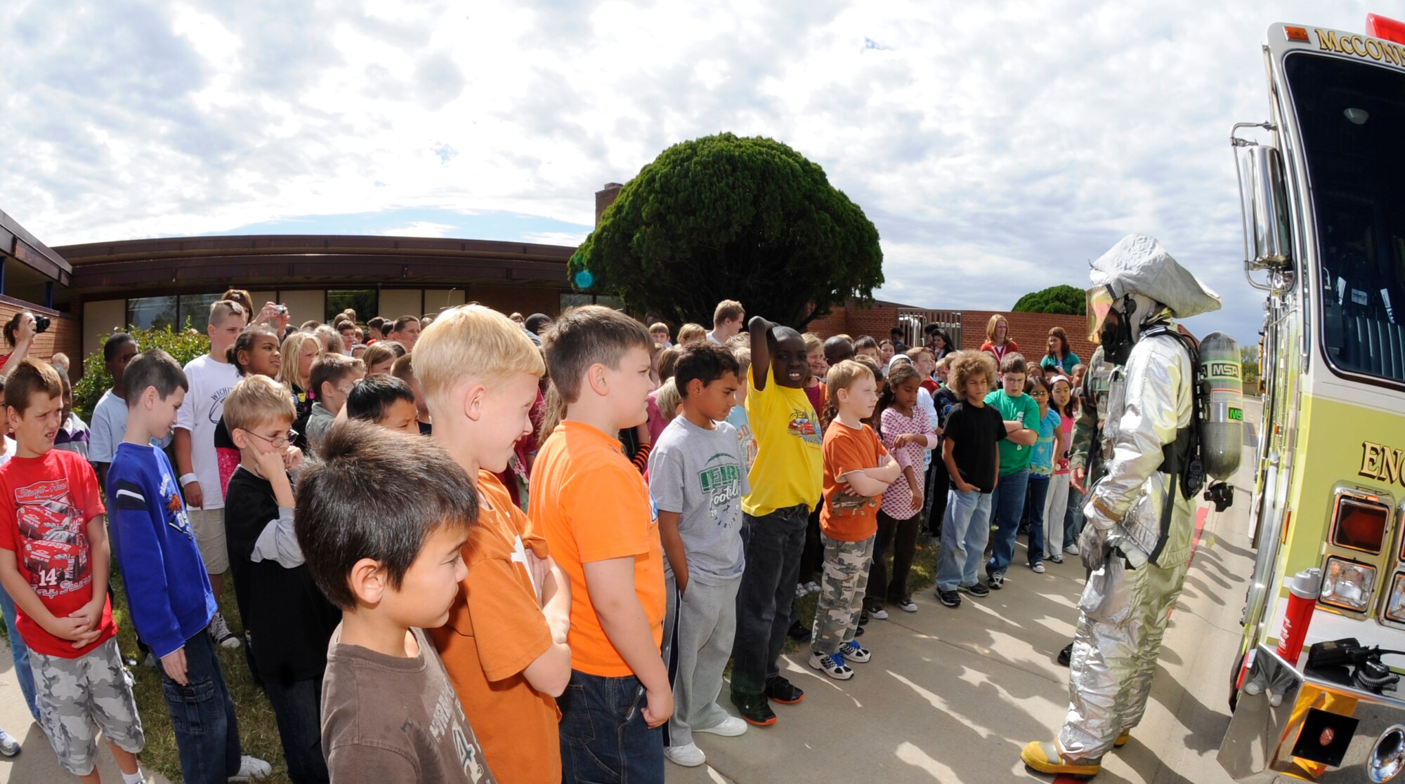 A McConnell firefighter talks to children at Wineteer Elementary School in Wichita, Kan., Oct. 7, 2009, about fire safety. Firemen also showed the students how a water apparatus on their truck helps battle fires. (U.S. Air Force photo/Staff Sgt. Jamie Train)