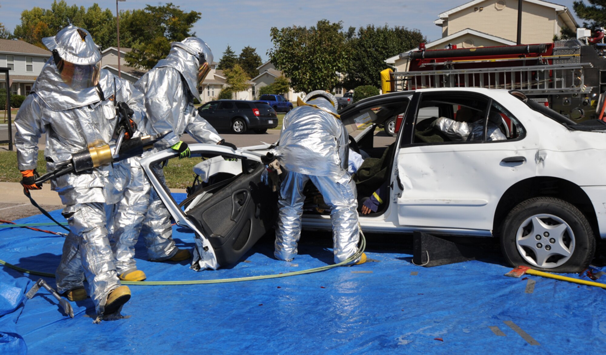 Firefighters from the 22nd Civil Engineer Squadron demonstrate how to extract and rescue a crash victim from a vehicle, Oct. 3, 2009, during Fire Prevention Extravaganza at McConnell Air Force Base, Kan. The event kicked off Fire Prevention Week at McConnell. (U.S. Air Force photo/Tech. Sgt. Chyrece Campbell)