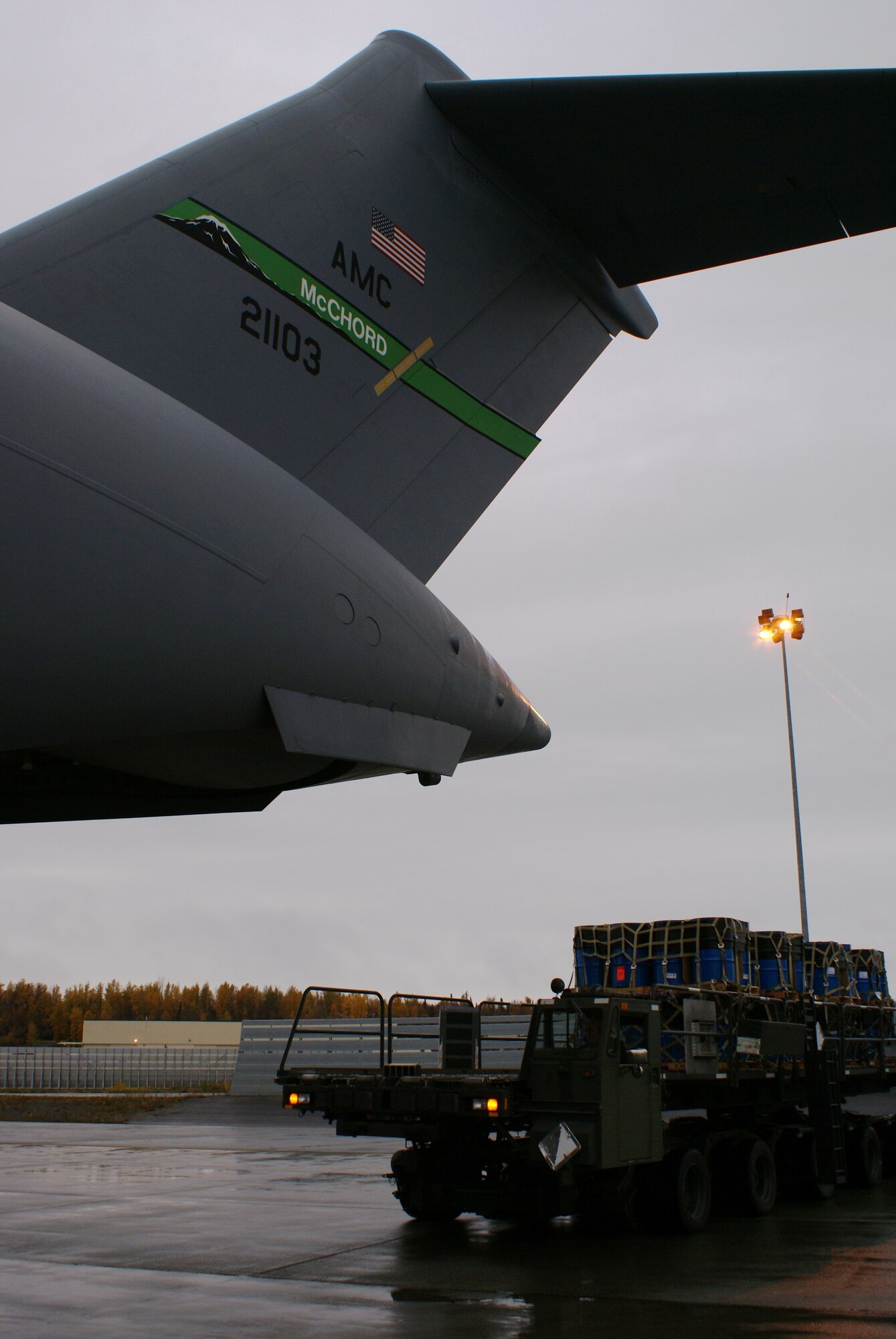 A 60K-Tunner approaches a McChord C-17 Globemaster III with cargo for a humanitarian mission Oct. 7 at Elmendorf Air Force Base, Alaska. More than 58,000 pounds of cargo - seven pallets of fuel for expeditionary hospital emergency generators and three pallets of medical supplies, ultimately destined for Indonesia - were loaded aboard the aircraft. (U.S. Air Force photo/Staff Sgt. Eric Burks)