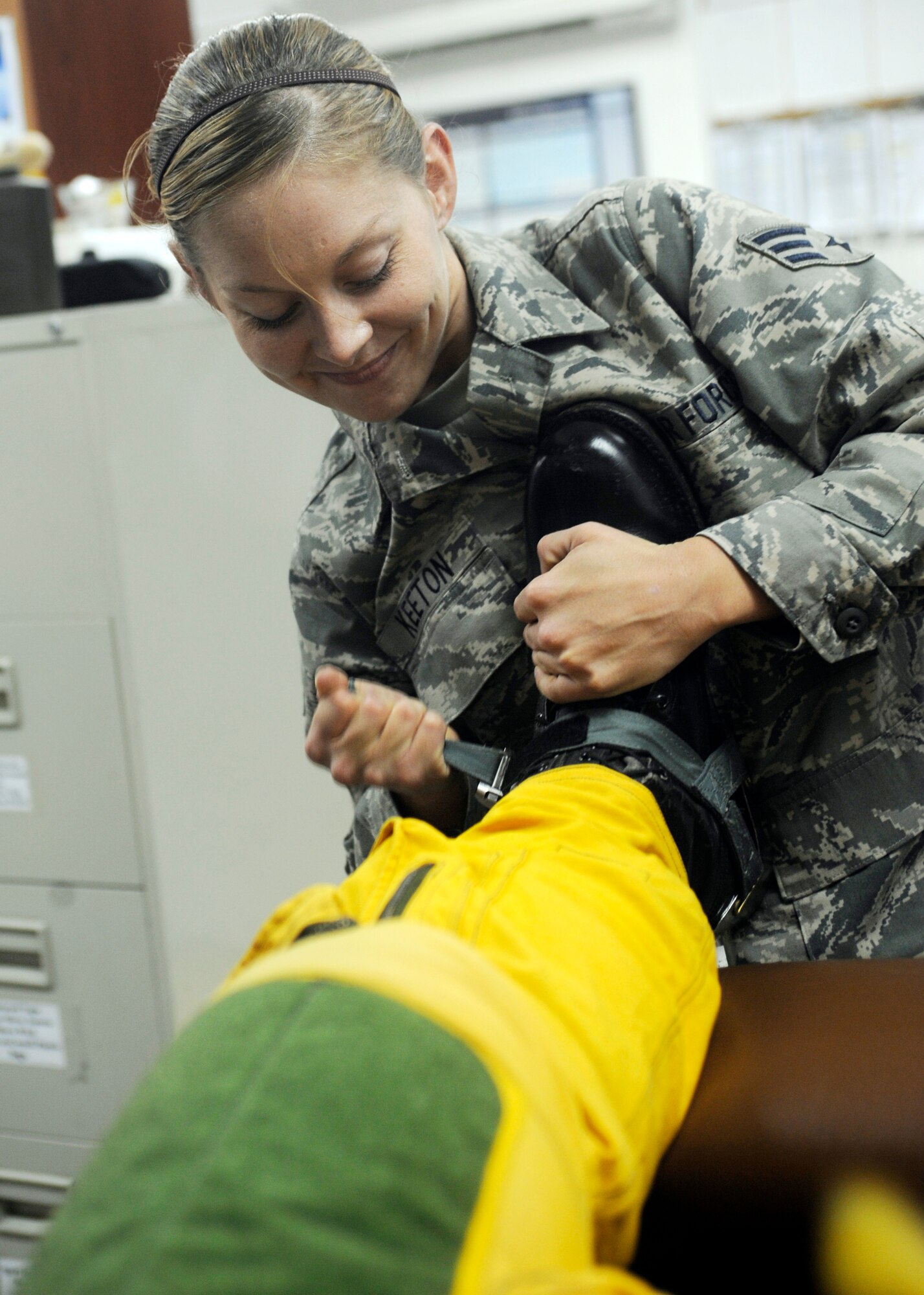 Senior Airman Lynette Keeton tightens the boots of Capt. Peter J. Gryn's flight suit Oct. 4, 2009. The sortie was Captain Gryn's first combat mission. Both Airmen are deployed from Beale Air Force Base, Calif. (U.S. Air Force photo/Staff Sgt. J.G. Buzanowski)