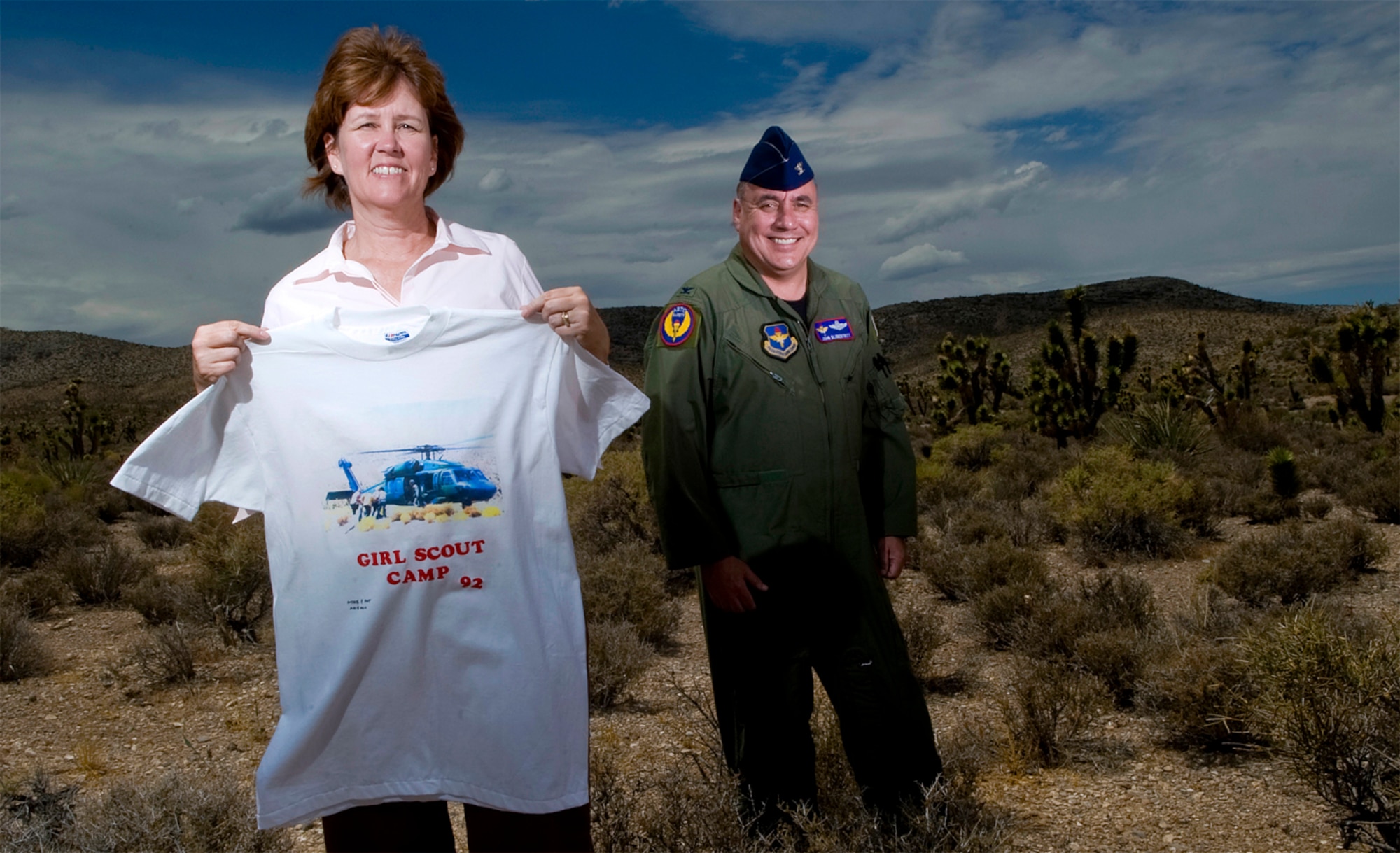DISASTER IN THE DESERT - Elaine Hardy displays a T-shirt that friends gave to her while she recovered in the hospital. The shirt includes a picture of emergency workers loading her onto the HH-60G. Col. John Blumentritt was one of the pilots on that flight. (U.S. Air Force photo by / Staff Sgt. Bennie J. Davis III)