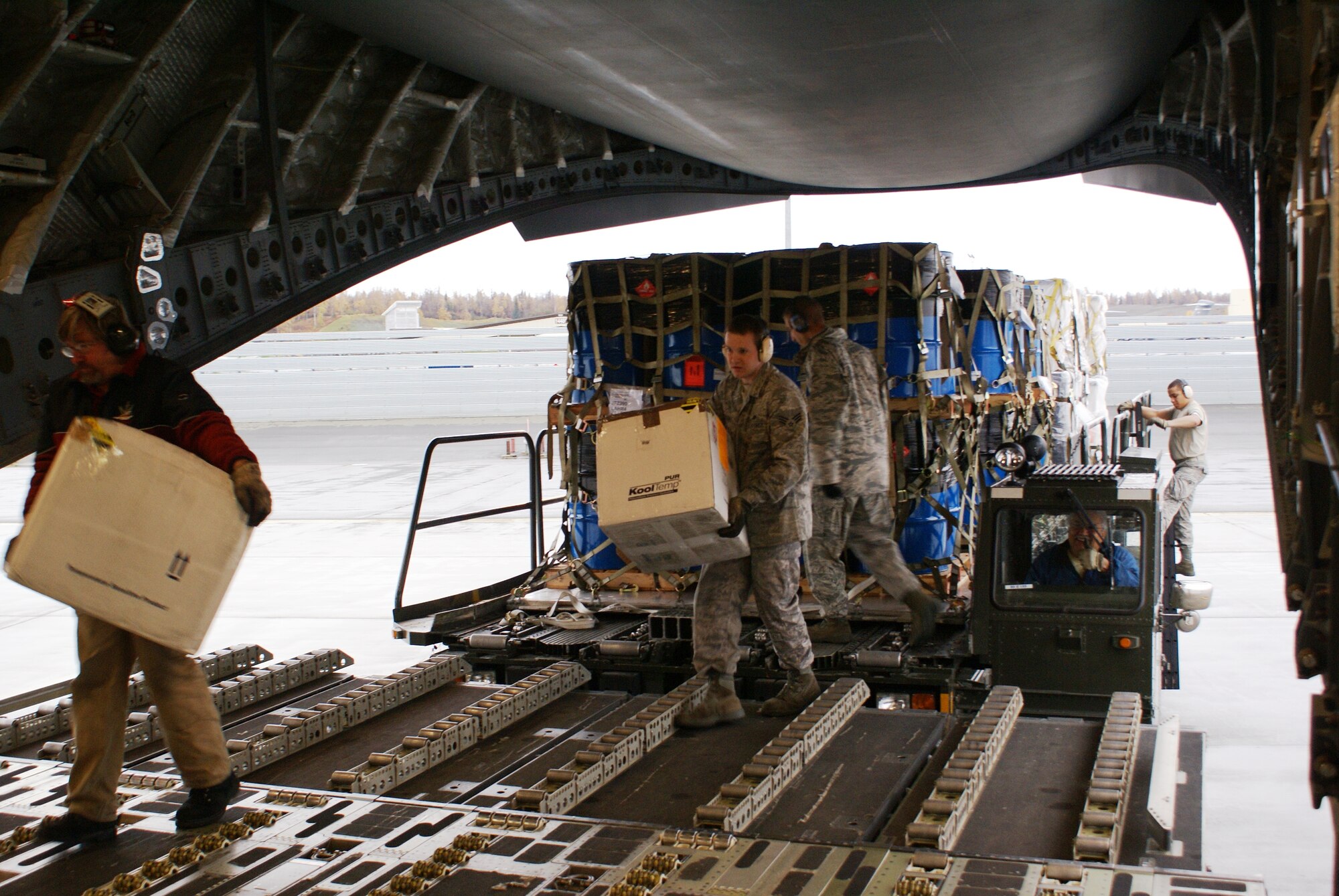 Elmendorf Air Force Base, Alaska, 732nd Air Mobility Squadron Airmen load cargo aboard a McChord C-17 Globemaster III on a humanitarian airlift mission Oct. 7. More than 58,000 pounds of cargo - seven pallets of fuel and three pallets of medical supplies, ultimately destined for Indonesia - were loaded aboard the aircraft. (U.S. Air Force photo/Staff Sgt. Eric Burks)