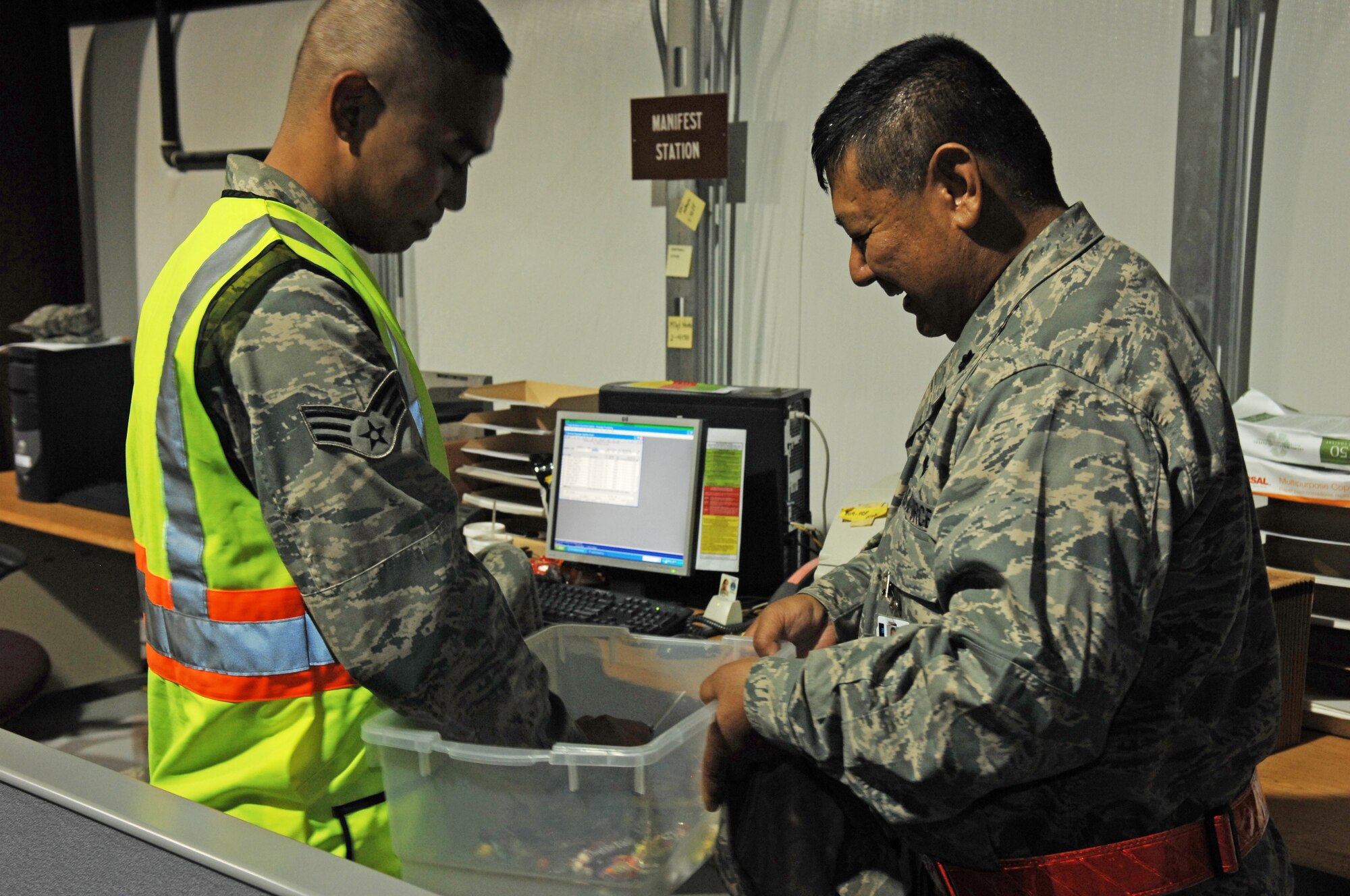 HOLLOMAN AIR FORCE BASE, N.M. -- Senior Airman Darryl Supertran, 49th Logistics Readiness Squadron, receives candy from Lt. Col. William Toguchi, 49th Fighter Wing chaplain, at the Personnel Deployment Facility at Basic Expeditionary Airfield Resources Base during Exercise Cornet Gold Rush here, Oct. 6. Passing out candy is a part of the Chapel's Unit Visitation with Airmen program to ensure morale and welfare stays at an elevated level throughout the exercise. The exercise scenario consisted of processing Airmen for deployment. (U.S. Air Force photo by Staff Sgt. Anthony Nelson Jr.)