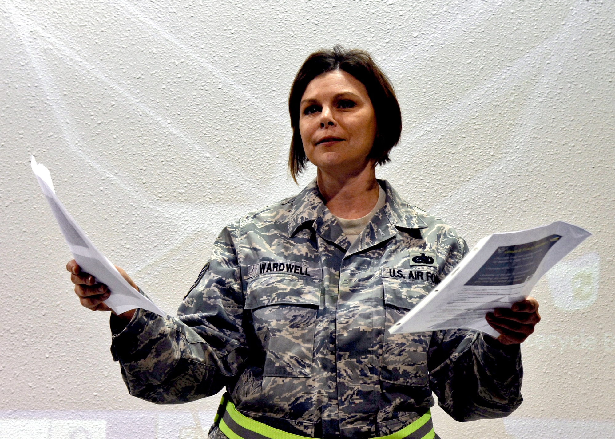 HOLLOMAN AIR FORCE BASE N.M. -- Tech Sgt. Judith Wardwell, superintendent of the Airman and Family Readiness Center, briefs military members about their resources while in the area of responsibility at the Personnel Deployment Facility at Basic Expeditionary Airfield Resources Base during Exercise Cornet Gold Rush here, Oct. 6. The exercise scenario consisted of processing Airmen for deployment. (U.S. Air Force photo by Staff Sgt.  Anthony Nelson Jr.)