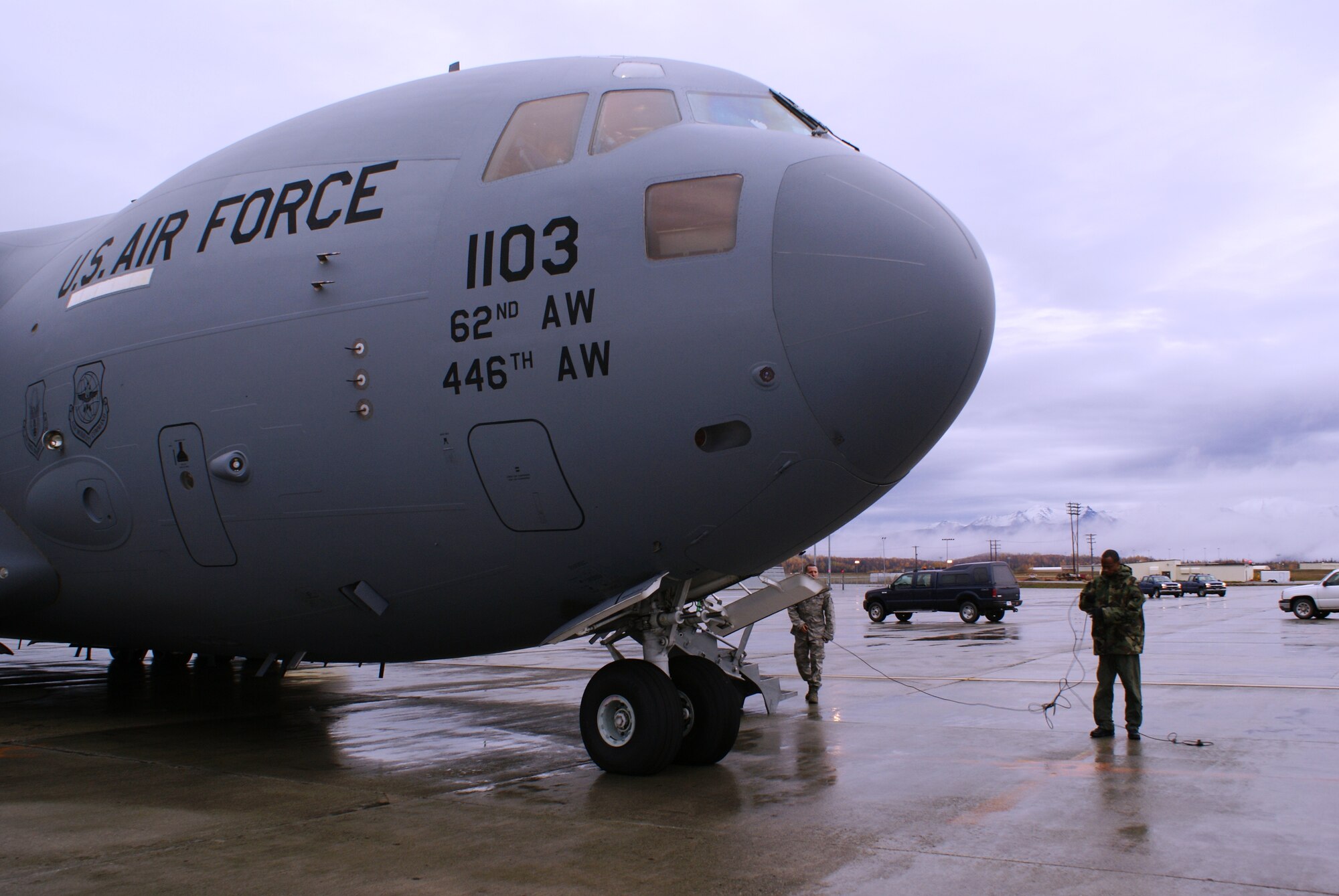 Aircrew go through final checks prior to the departure of a McChord C-17 Globemaster III on a humanitarian airlift mission Oct. 7 at Elmendorf Air Force Base, Alaska. More than 58,000 pounds of cargo - seven pallets of fuel and three pallets of medical supplies ultimately destined for Indonesia - were loaded aboard the aircraft by aircrew and members of Elmendorf's 732nd Air Mobility Squadron. (U.S. Air Force photo/Staff Sgt. Eric Burks)
