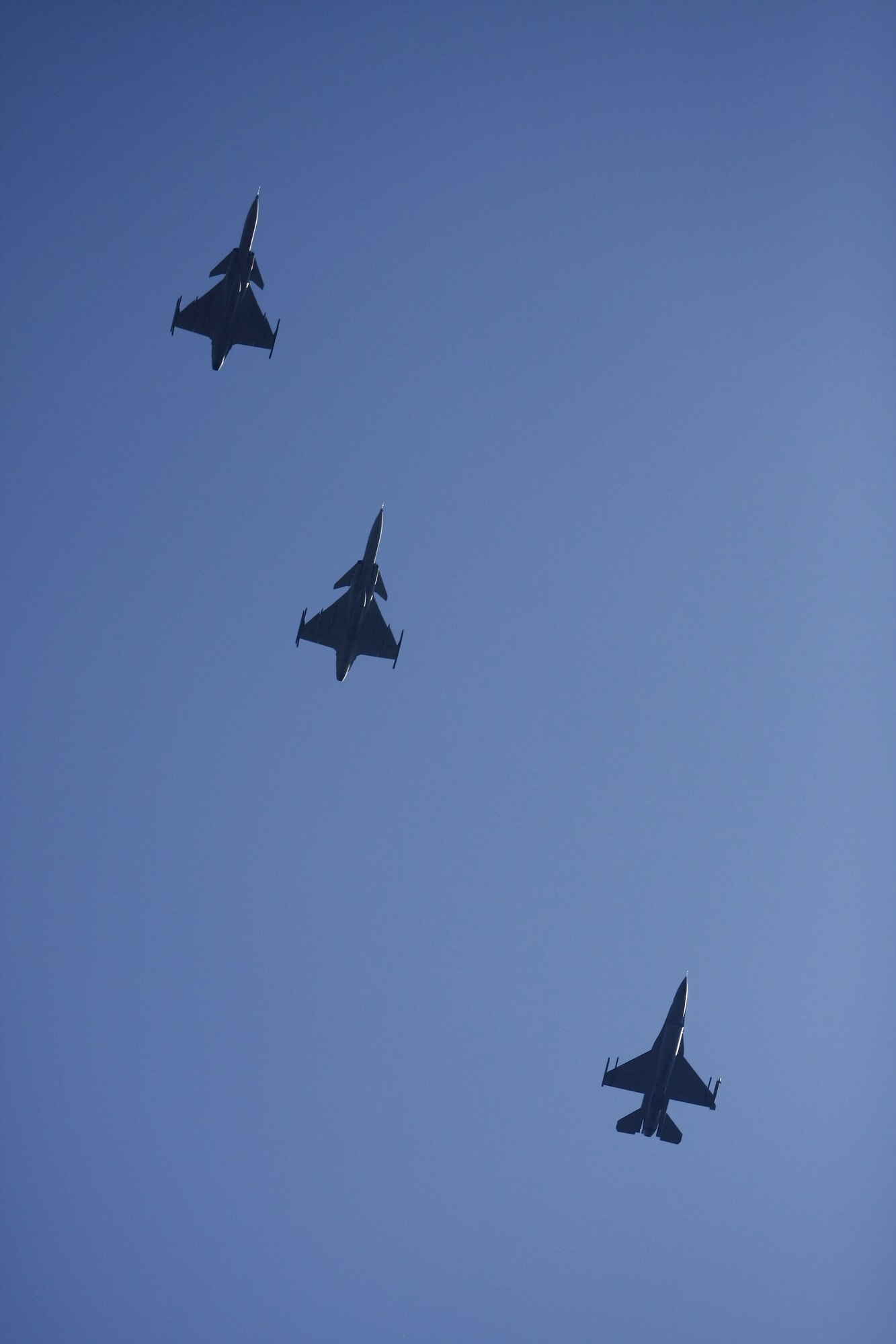 Two Czech Grippens and an F-16 cast silhouettes as the fly over Caslav Air Base.   Members of the Texas Air National Guard’s 149th Fighter Wing were in the Czech Republic conducting mutual training as part of the National Guard’s state partnership program.  (U.S. Air Force photo by Capt Randy Saldivar)