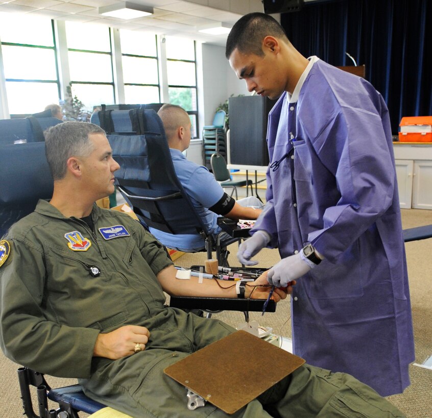 LANGLEY AIR FORCE BASE, Va – Juan Ramirezalcala, United States Navy hospital apprentice, extracts blood from Lt. Col. John Taylor, Headquarters Air Combat Command chief of training air operations center, during a blood drive here Oct. 7. Langley held a blood drive to help the Armed Services Blood Program ship donations in support of Operations Iraqi Freedom and Enduring Freedom. (U.S. Air Force photo/Senior Airman Dana Hill)