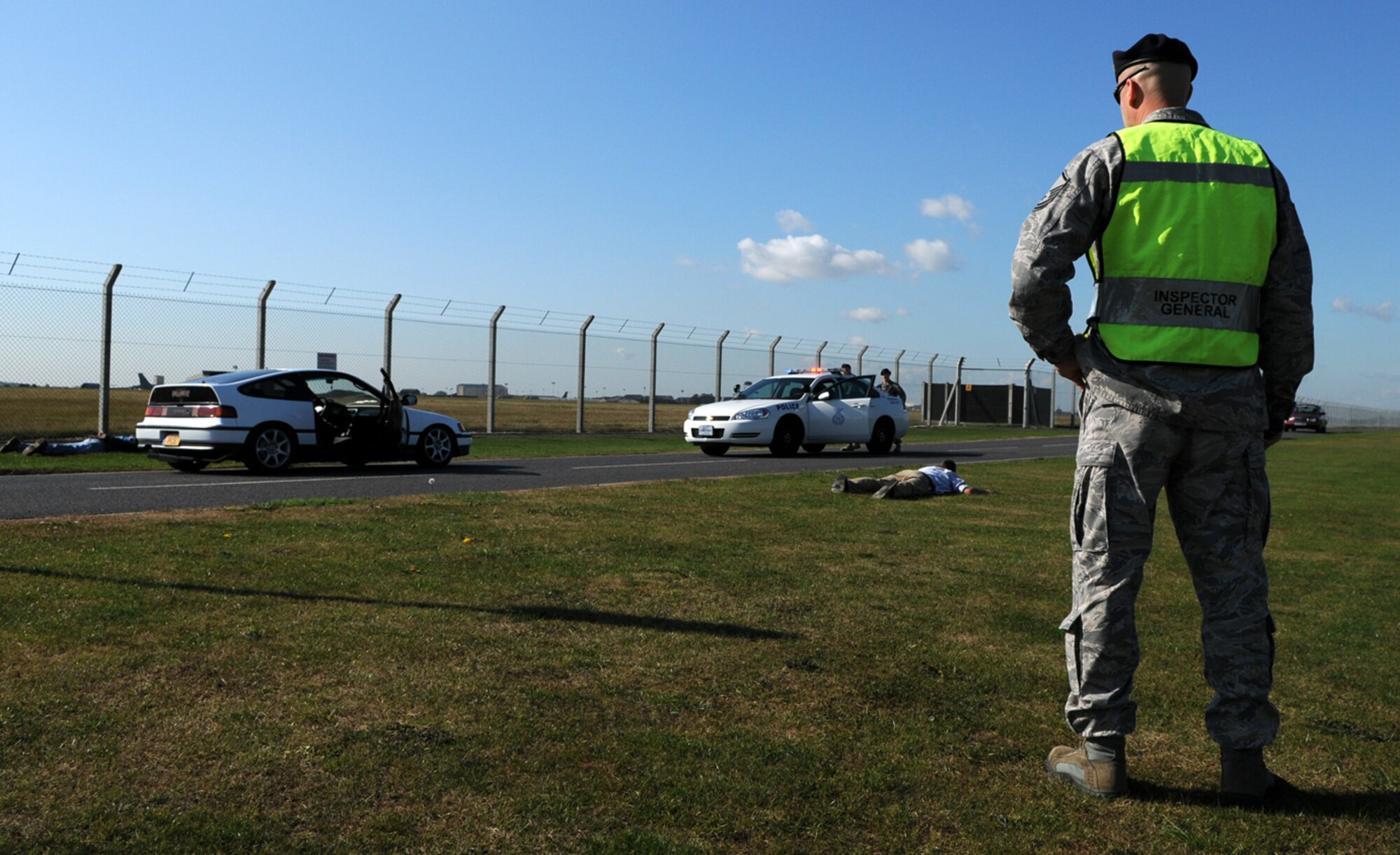 RAF MILDENHALL, England -- Master Sgt. Blake Holm, U.S. Air Forces in Europe Inspector General team, evaluates the performance of 100th Security Forces Squadron Airmen who intercepted a vehicle after its occupants entered the base without authorization.  The scenario was part of a two-week Operational Readiness Inspection here. (U.S. Air Force photo/Staff Sgt. Austin M. May)