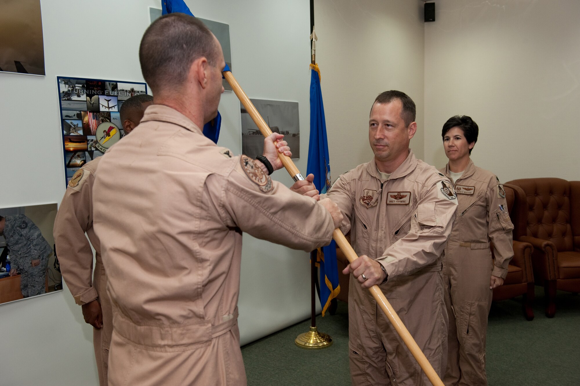 Lt. Col. Bret Frymire accepts the 340th Expeditionary Air Refueling Squadron guidon from 379th Expeditionary Operations Group Commander Col. David Been, upon assumption of command, Oct. 2. The 340 EARS provides aerial refueling support to Air Force, Navy, Marine Corps and allied nation aircraft that fly missions in support of Operations Iraqi and Enduring Freedom. (U.S. Air Force Photo/Staff Sgt. Robert Barney)