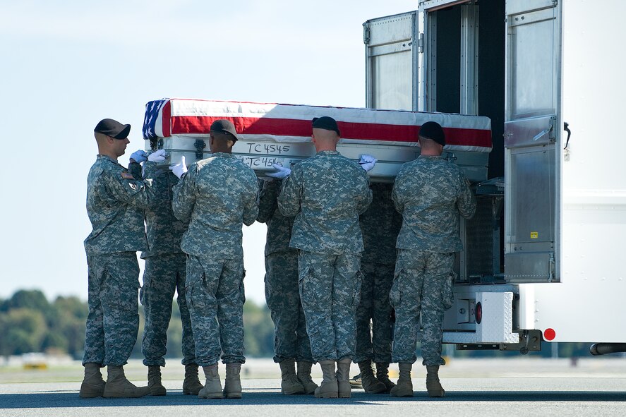 A U.S. Army carry team transfers the remains of Army Sgt. Joshua J. Kirk, of South Portland, Maine, at Dover Air Force Base, Del., October 6. Sgt. Kirk was assigned to the 3rd Squadron, 61st Cavalry Regiment, 4th Brigade Combat Team, 4th Infantry Division, Fort Carson, Colo. (U.S. Air Force photo/Roland Balik)