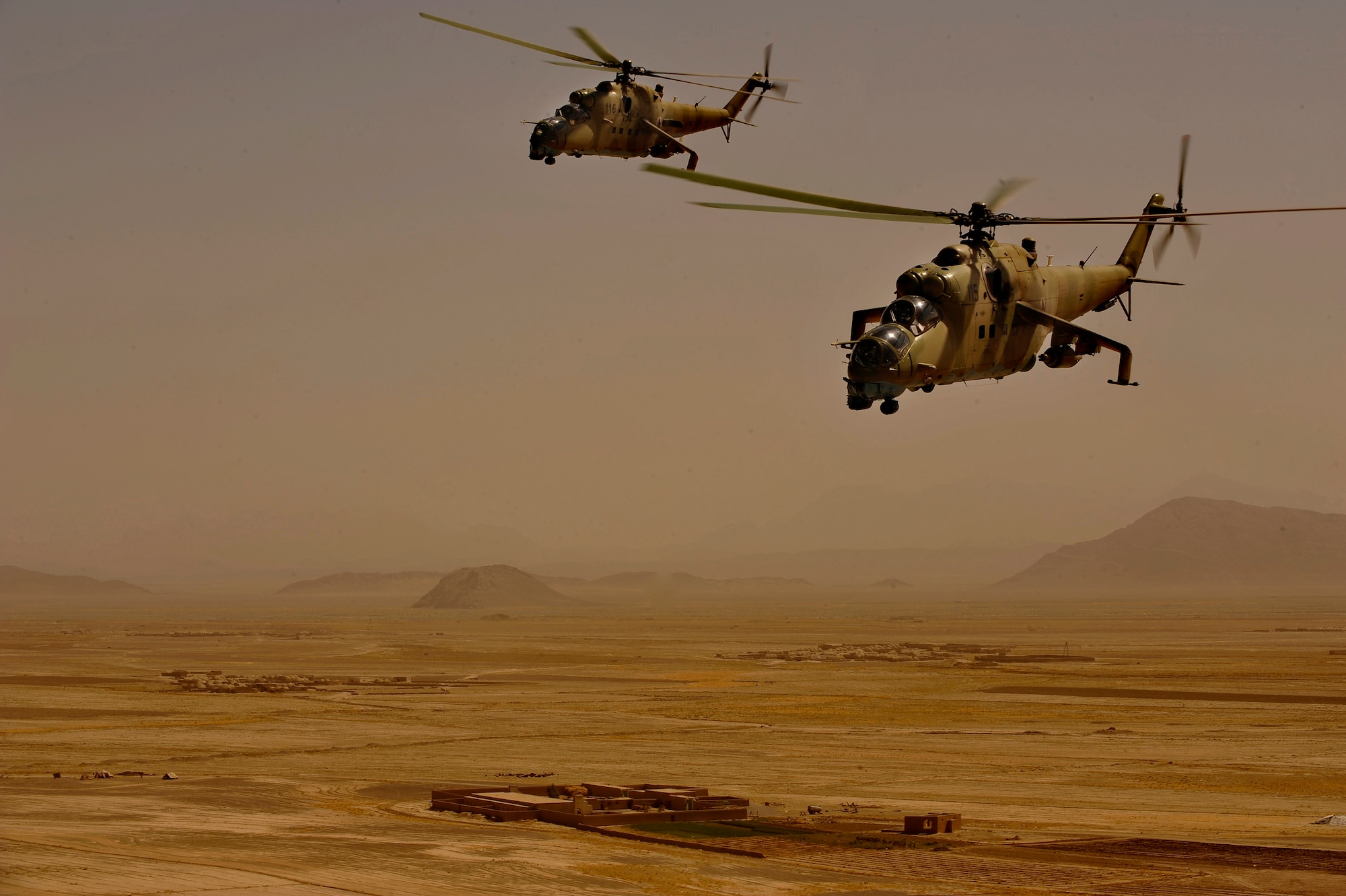 Afghan National Army Air Corp Airmen pilot two Mi-35 helicopters during a training sortie, with support from Czech Republic and U.S. coalition partners, over southern Afghanistan Oct. 3, 2009. (U.S. Air Force photo/Staff Sgt. Angelita Lawrence)