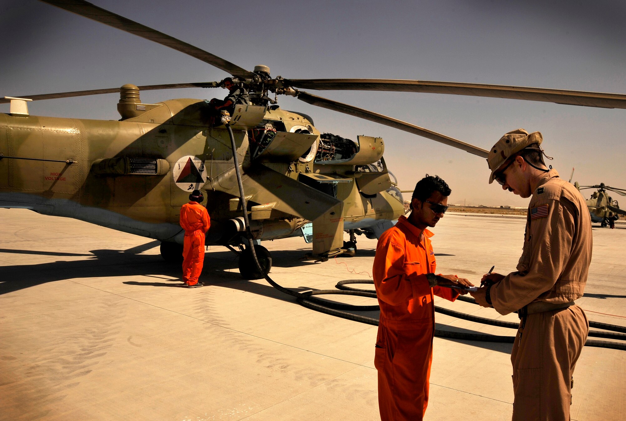 U.S. Air Force Capt. R. Tyler Rennell, a pilot mentor from the 450th Air Expeditionary Training Squadron, signs a receipt for fuel at Kandahar Air Field Oct. 2, 2009.  Captain Rennell is part of the 438th AETS, the units mission is to mentor Afghans on flying operations. (U.S. Air Force photo/Staff Sgt. Angelita Lawrence)
